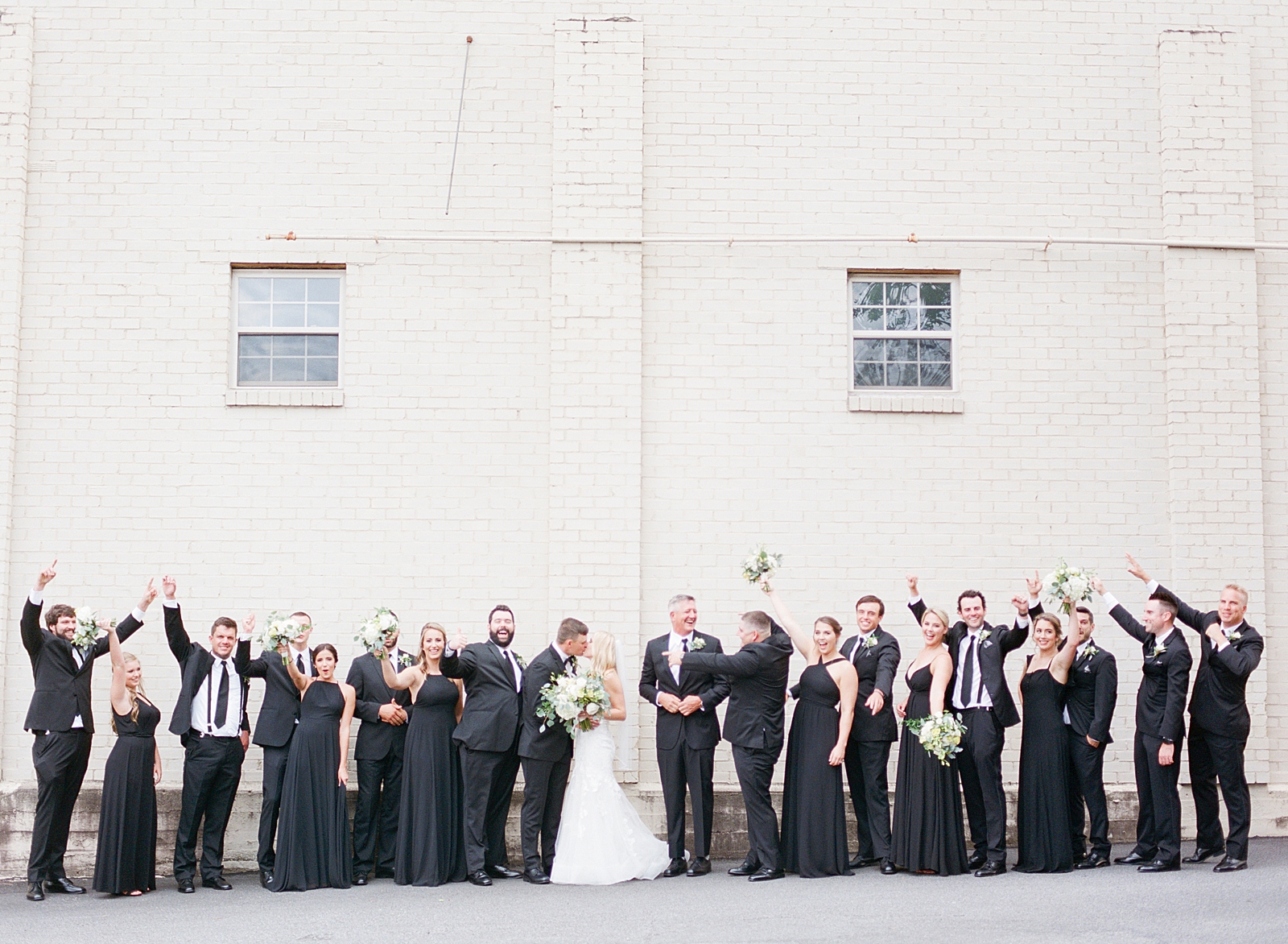 Glover Park Brewery Wedding Bride and Groom Kissing and Wedding Party Cheering Photo