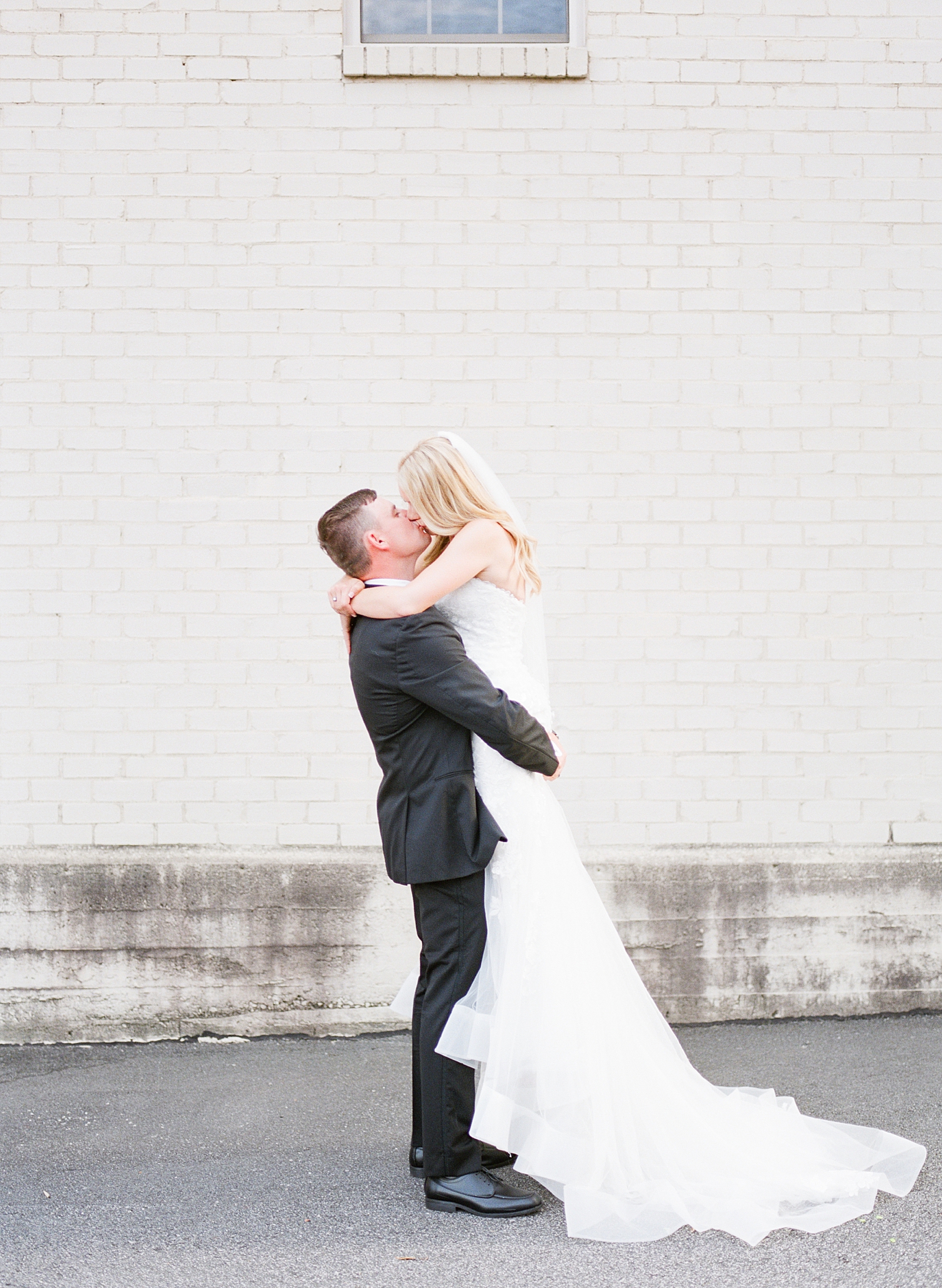 Glover Park Brewery Wedding Groom Holding Bride and Kissing Photo