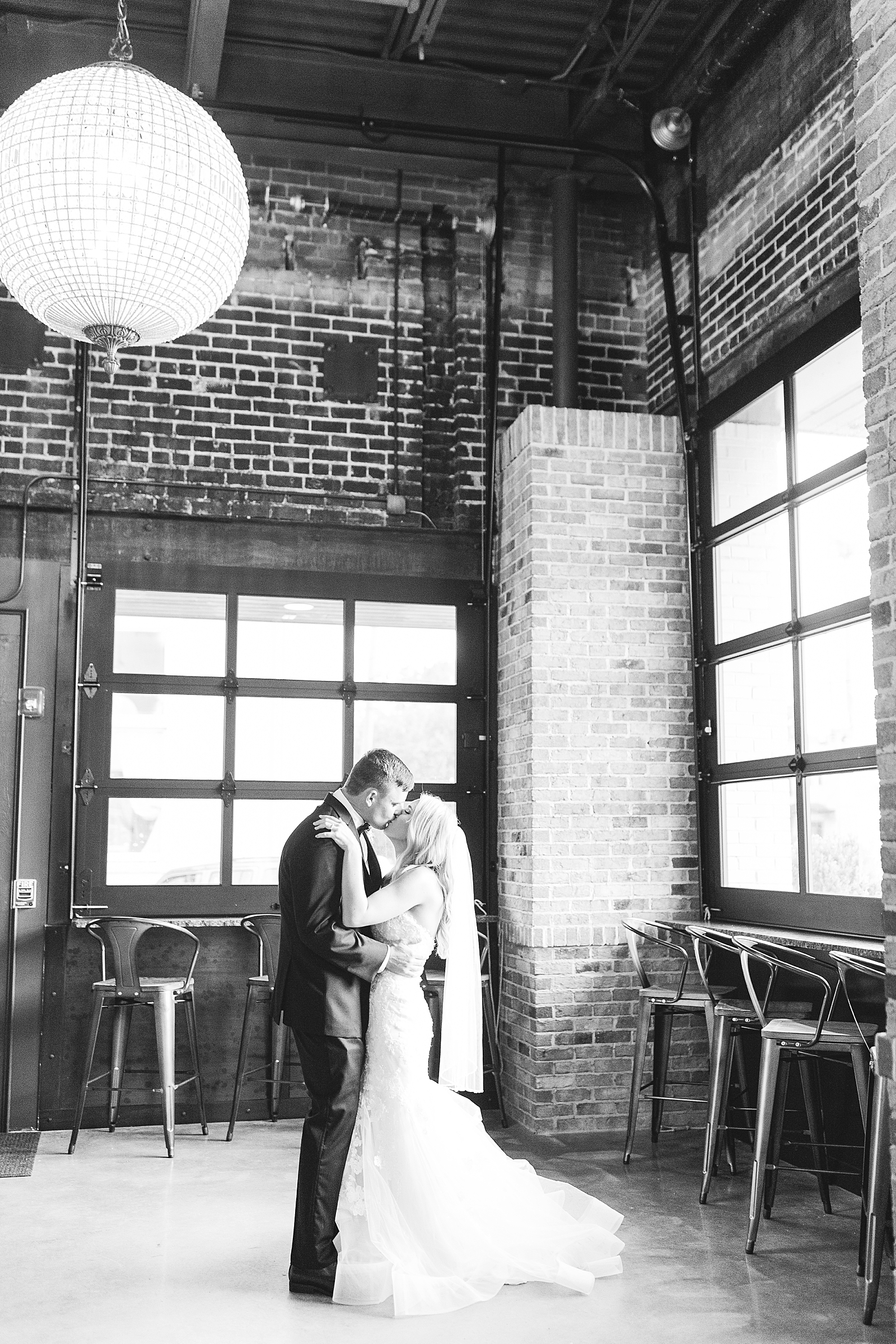 Glover Park Brewery Wedding Black and White of Couple Kissing in front of venue Photo
