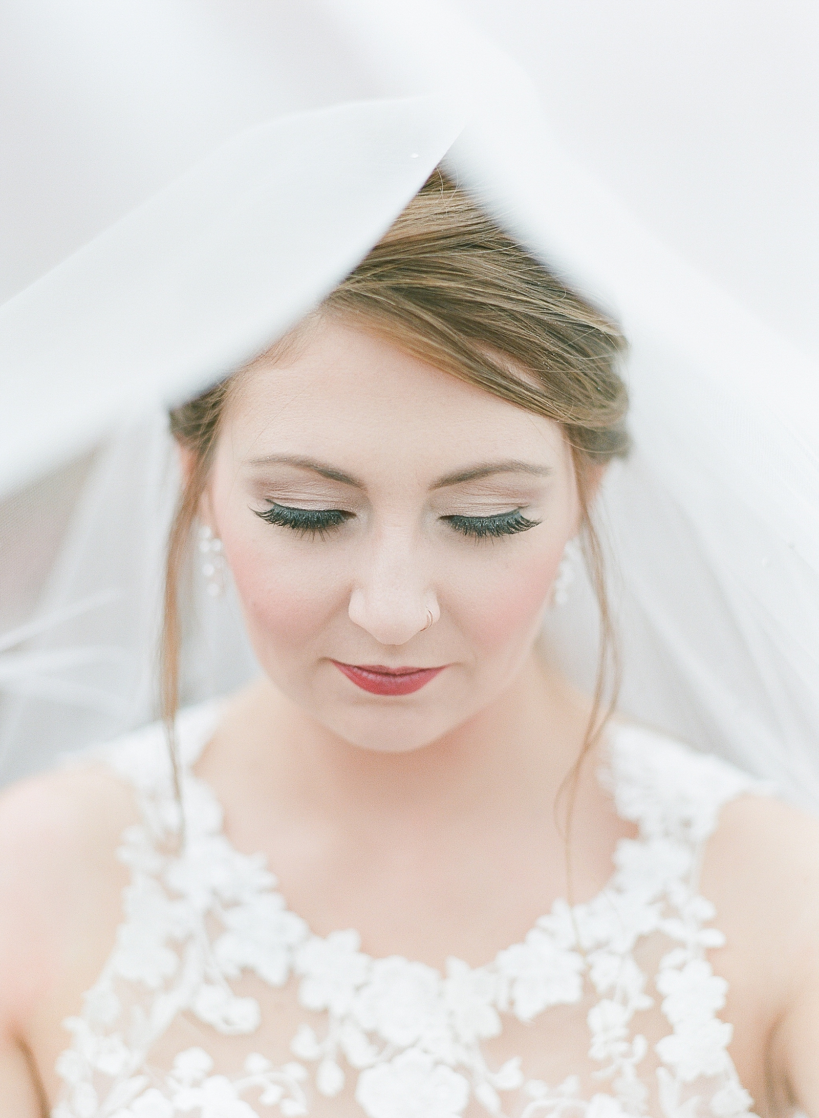 Asheville Bridal Editorial Bride with Veil over her head looking down Photo