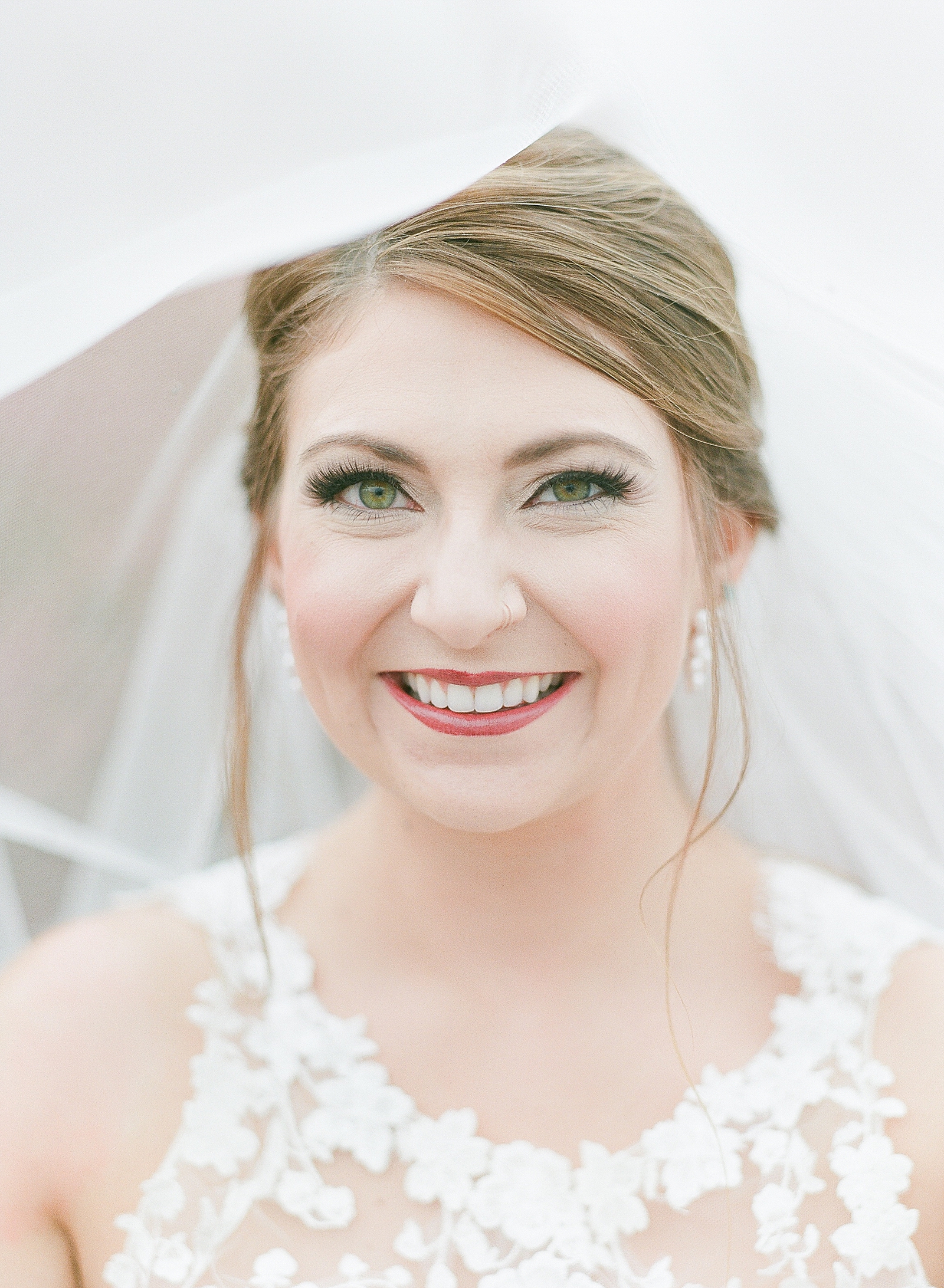 Asheville Bridal Editorial Bride Smiling at Camera Under Veil Photo