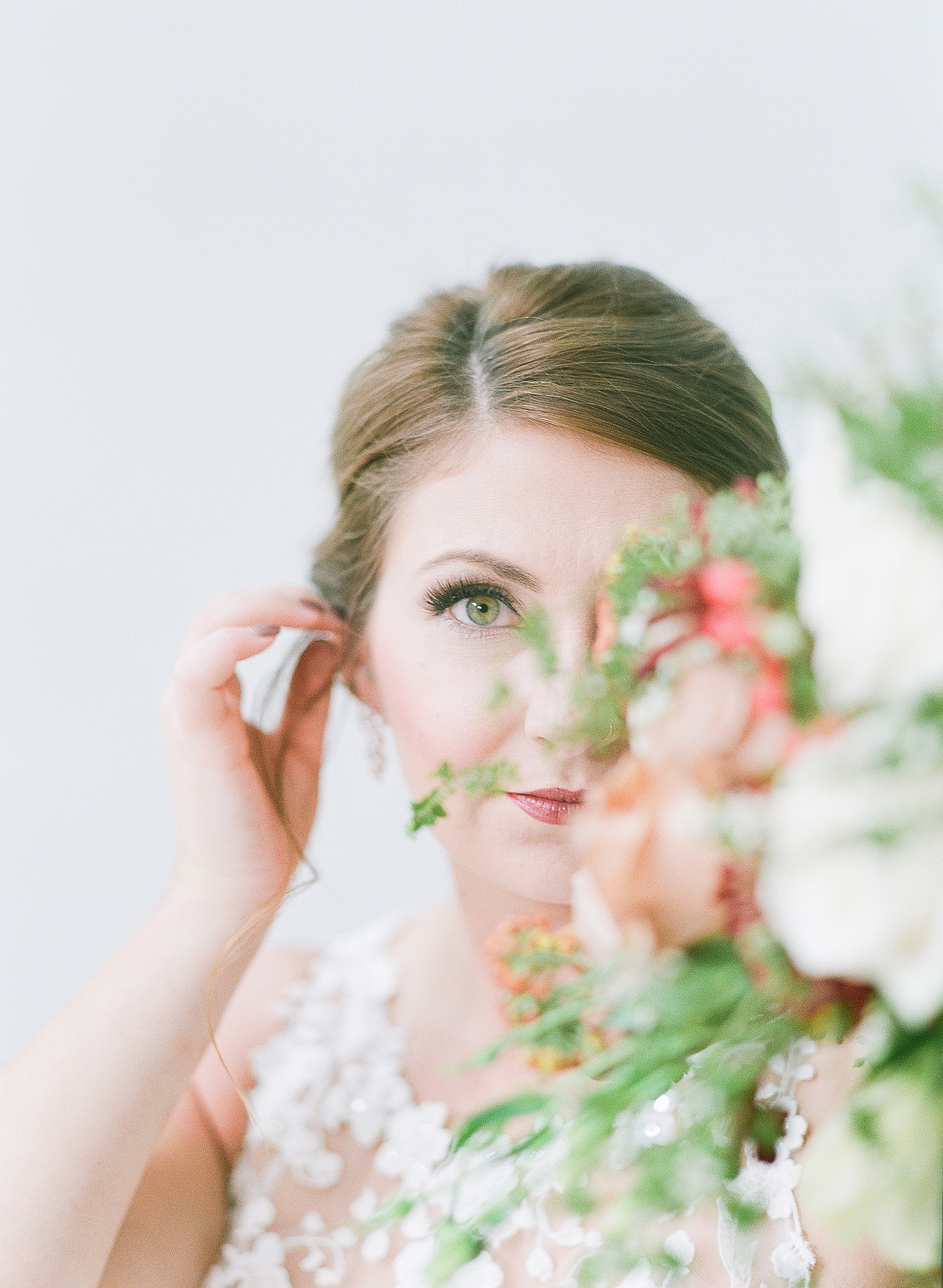 Asheville Bridal Editorial Bride Looking at Camera with Flowers in Foreground Photo