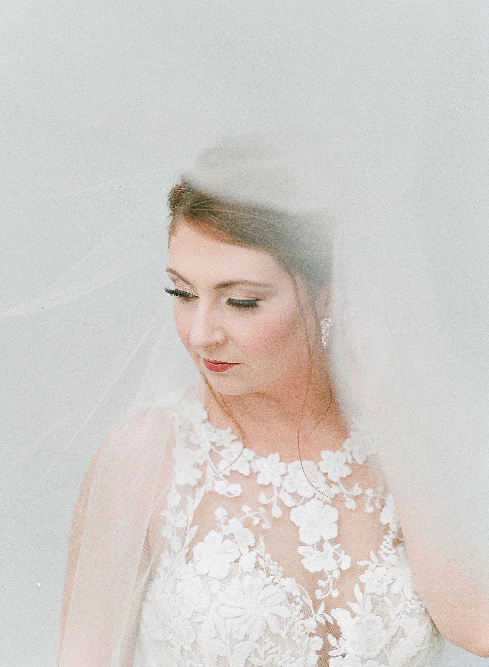 Asheville Bridal Editorial Bride Looking Down Under Veil Photo