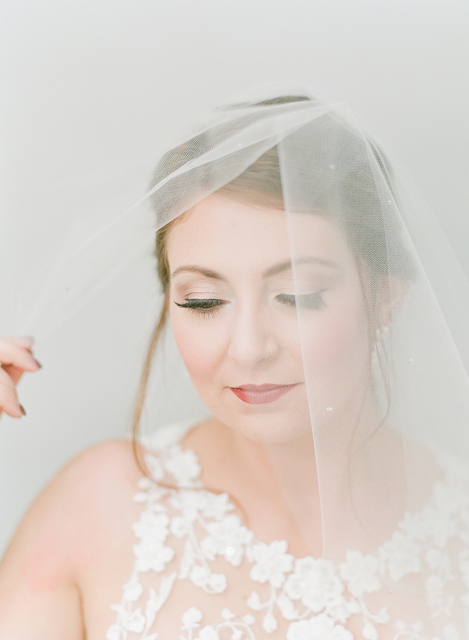 Asheville Bridal Editorial Bride Looking Down With Veil Photo