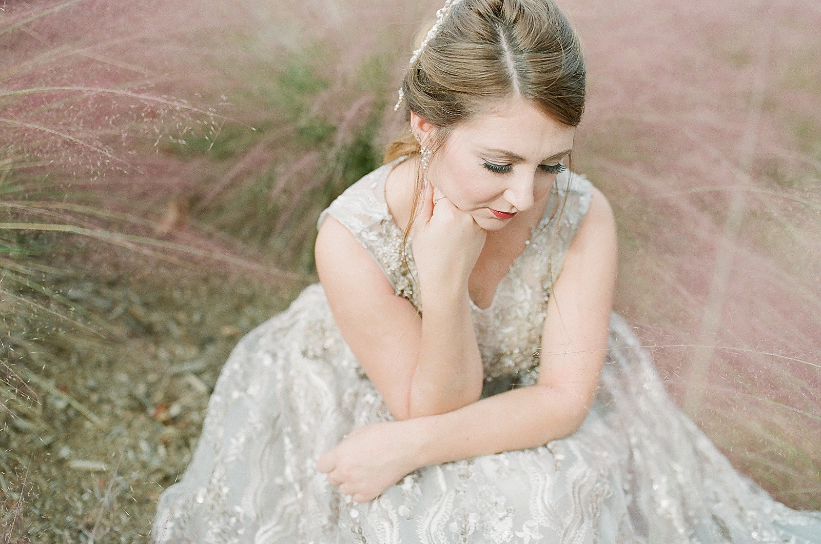 Asheville Bridal Editorial Bride Sitting in Mauve Flowers looking Down Photo