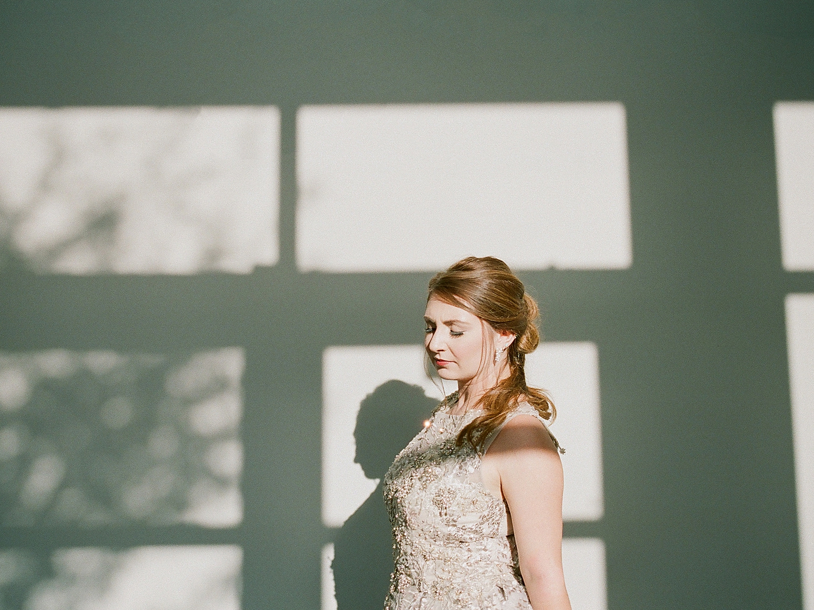 Asheville Bridal Editorial Bride Looking Down with Shadows on the Wall Photo