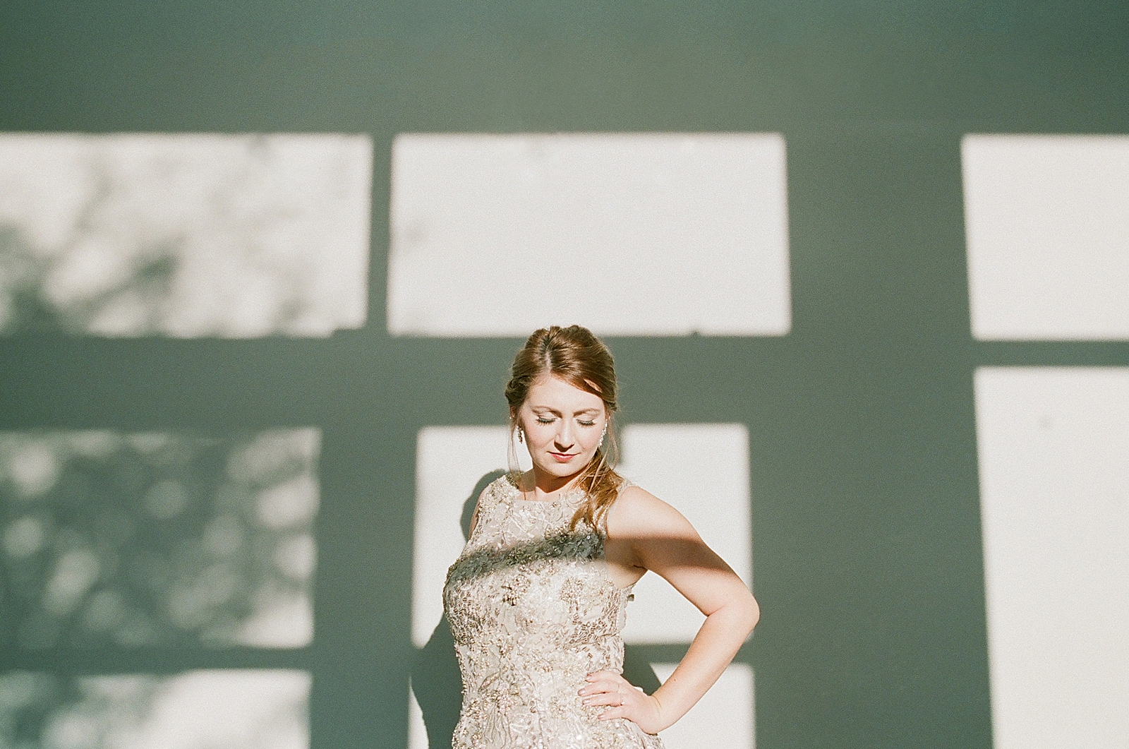 Asheville Bridal Editorial Bride Looking Down with Shadows on the Wall Behind Photo