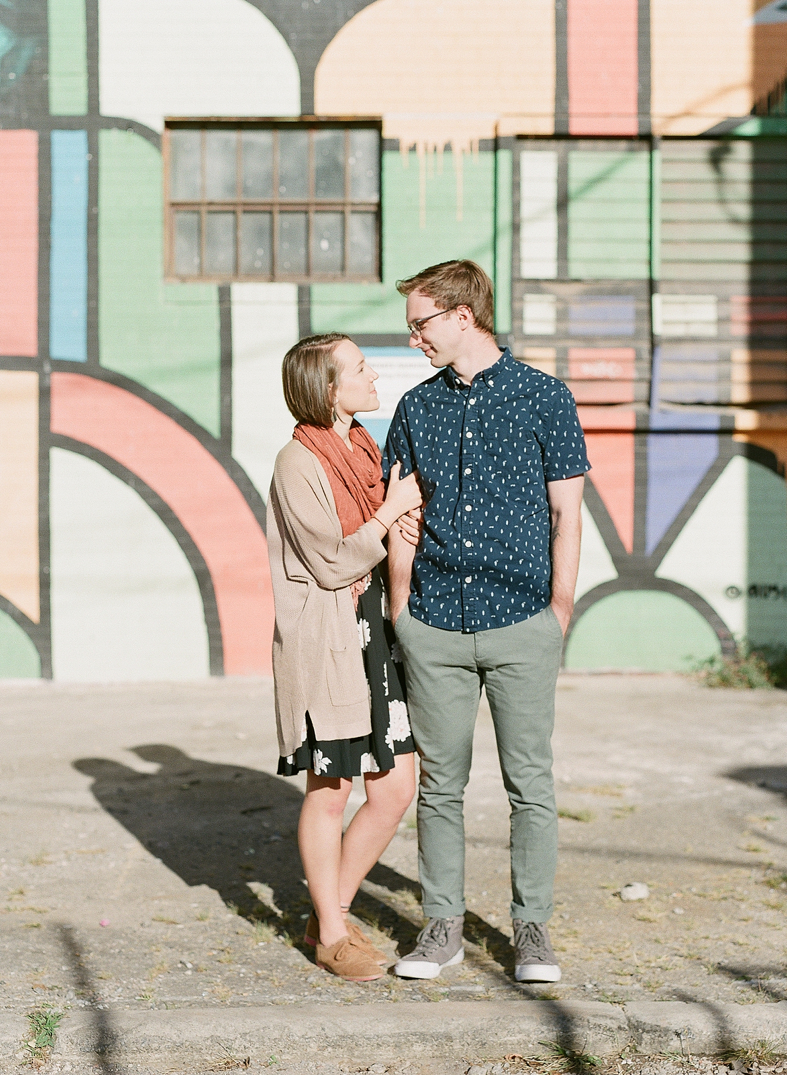 Downtown Asheville Engagement Session Couple Looking at each other hugging in front of graffiti wall Photo