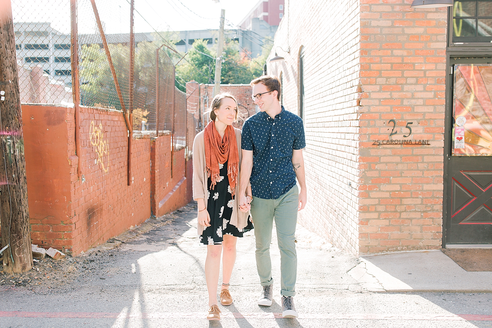 Downtown Asheville Engagement Session Couple Holding Hands walking toward the Camera Photo