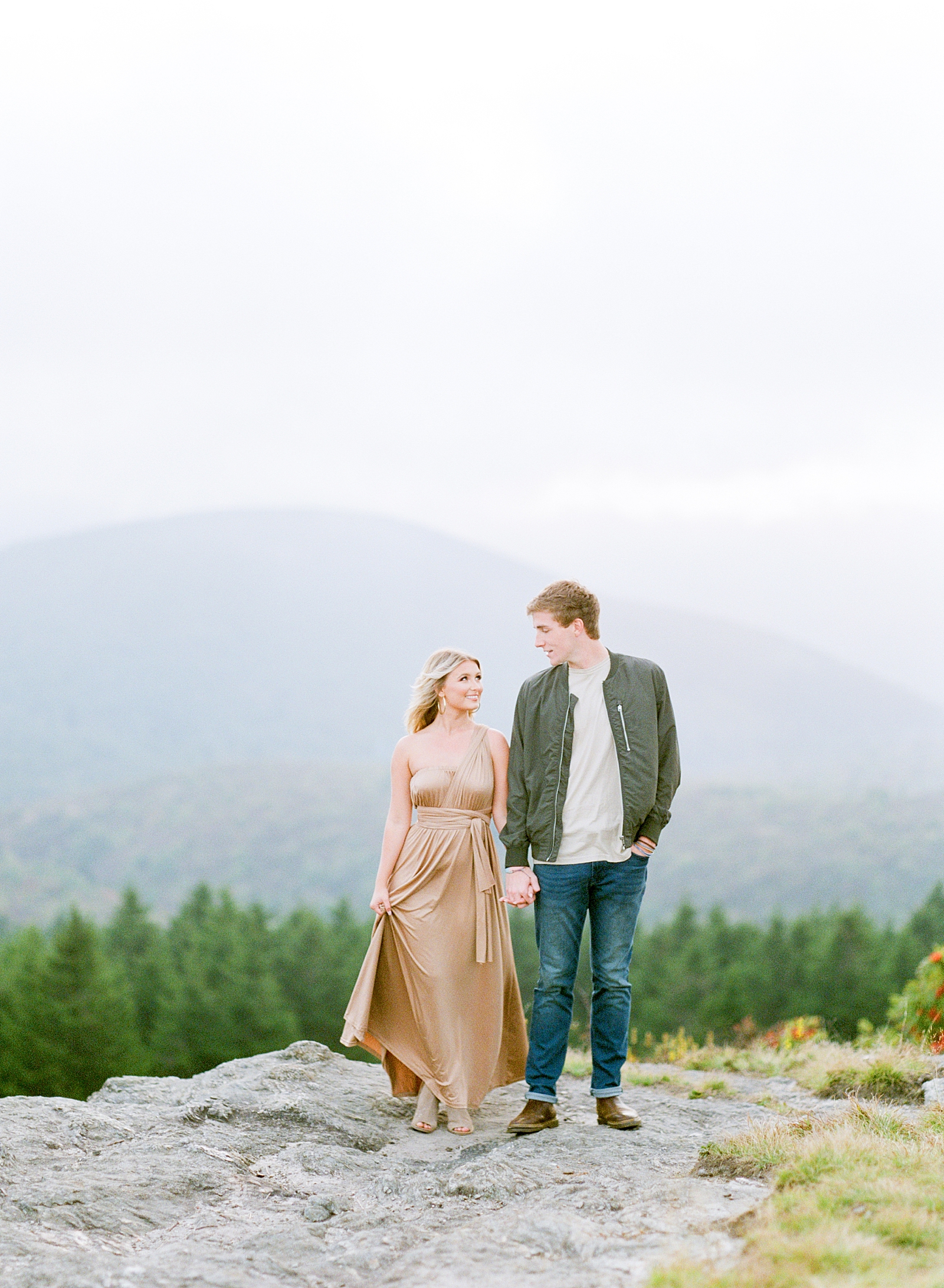 Asheville Mountaintop Session Couple Holding Hands Smiling at Each Other Photo