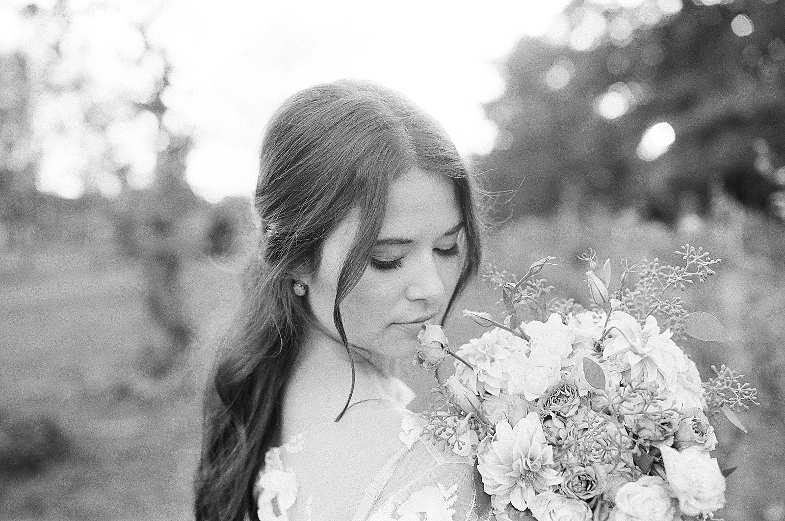 Asheville Wedding Photographer Black and White of Bride looking over shoulder with bouquet on shoulder Photo