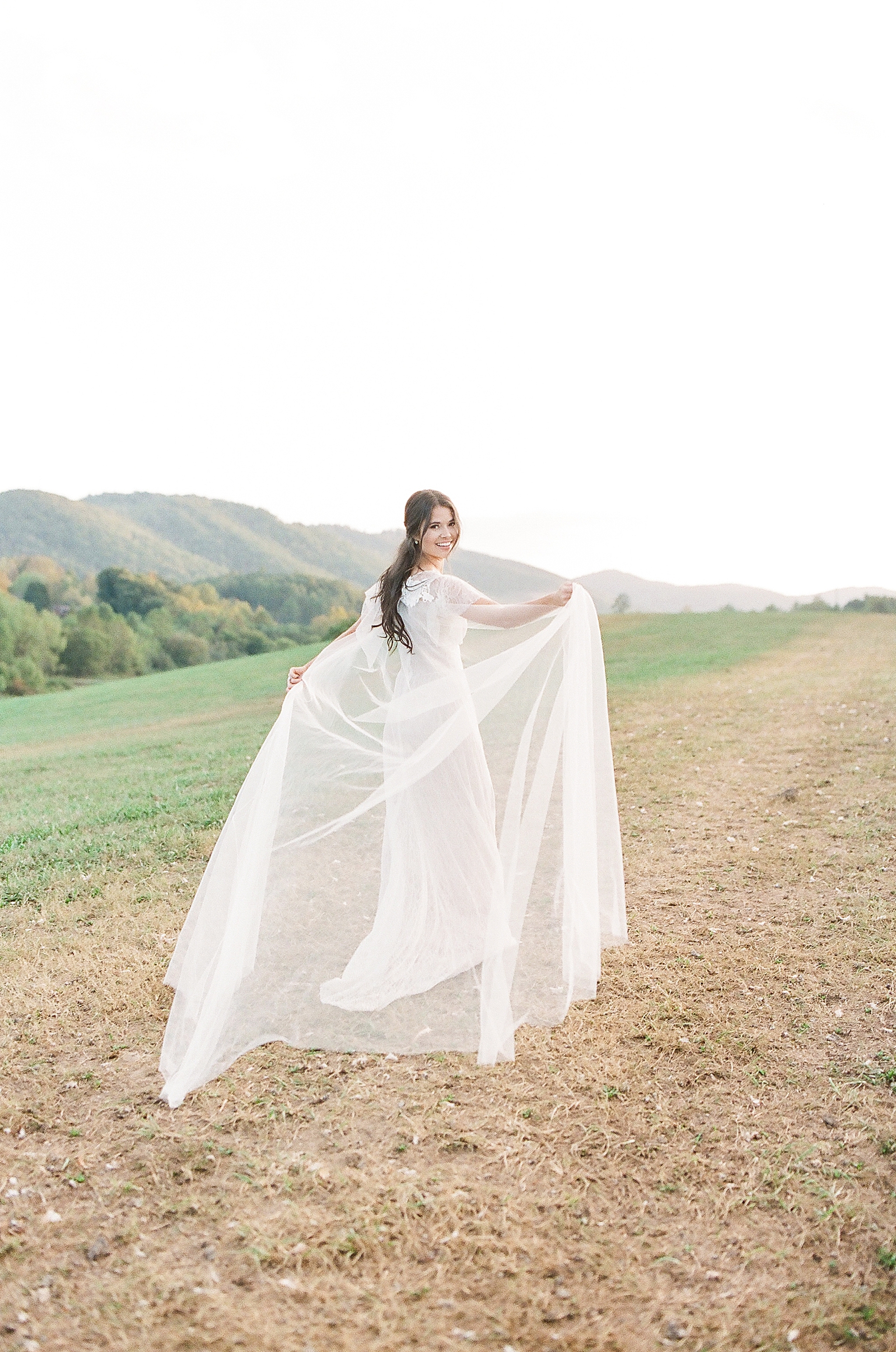 Asheville Wedding Photographer Bridal Editorial Bride Looking Over Her Shoulder Holding Veil Photo