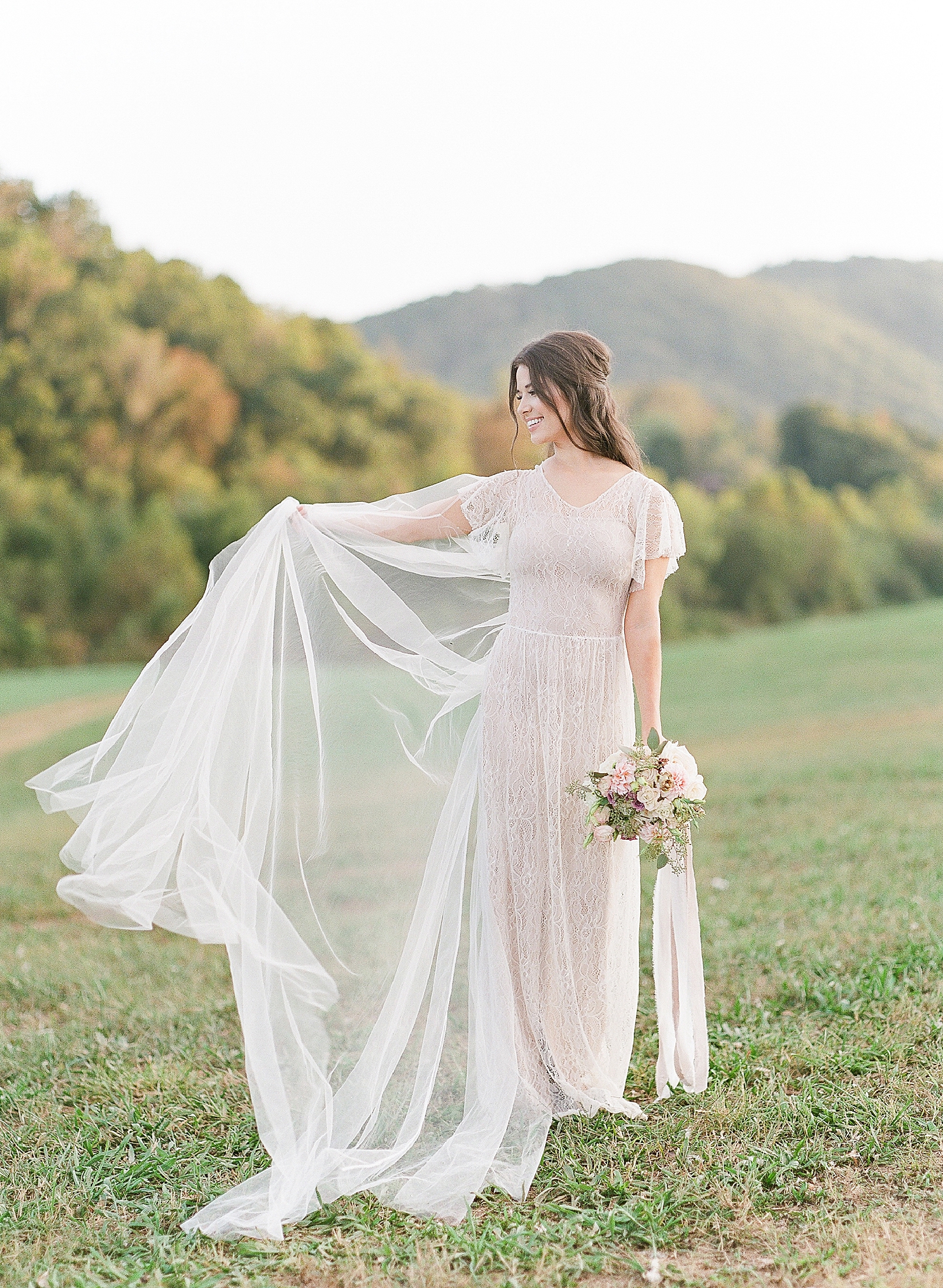 Asheville Wedding Photographer Bridal Editorial Bride Fluffing her veil Photo
