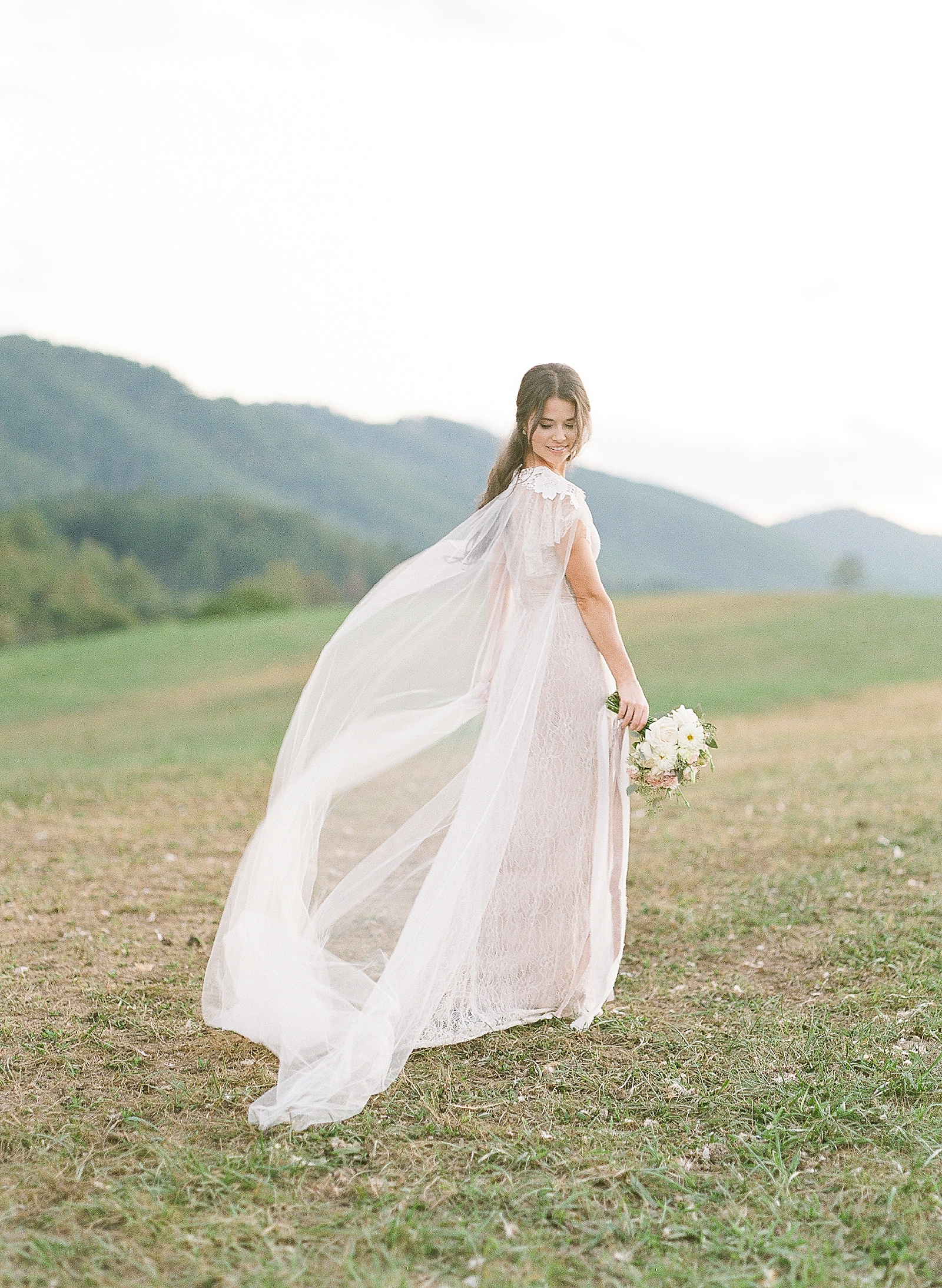 Asheville Wedding Photographer Bridal Editorial Bride Looking Down over Shoulder with veil flowing Photo