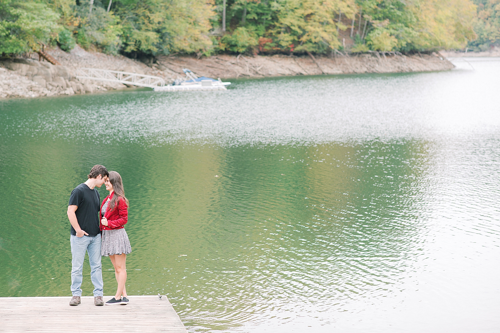 Mountaintop Engagement Couple Snuggling on dock nose to nose Photo 