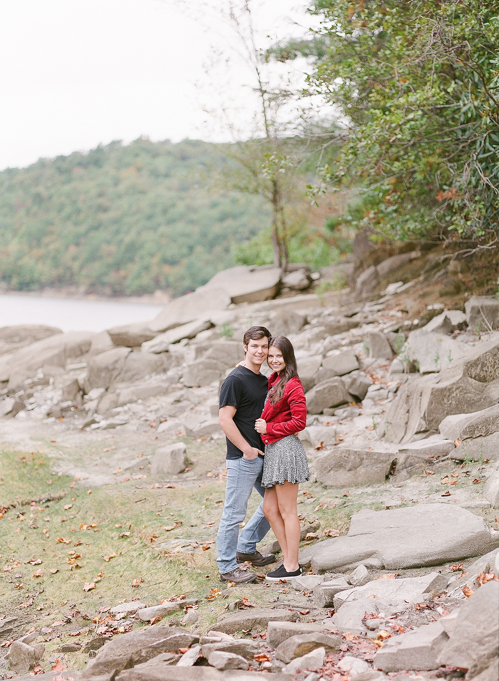 Mountaintop Engagement Couple hugging smiling at camera on rocks Photo 