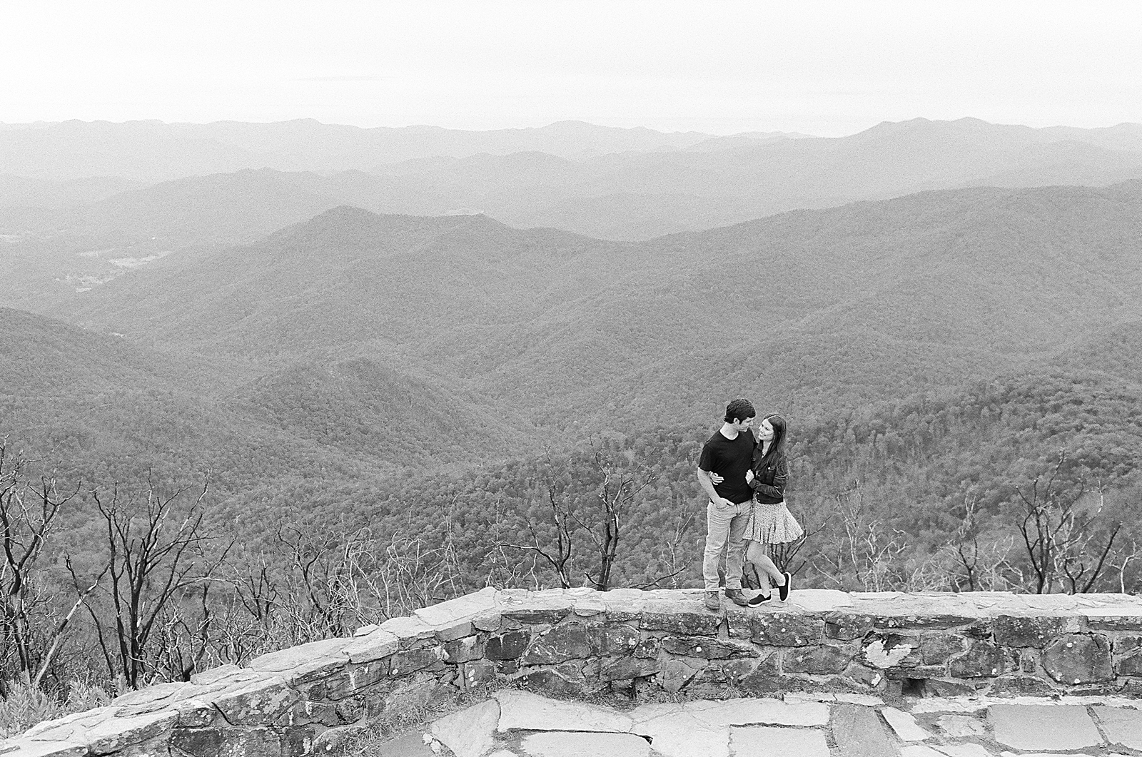 Mountaintop Engagement Black and White of couple with mountains behind them Photo 