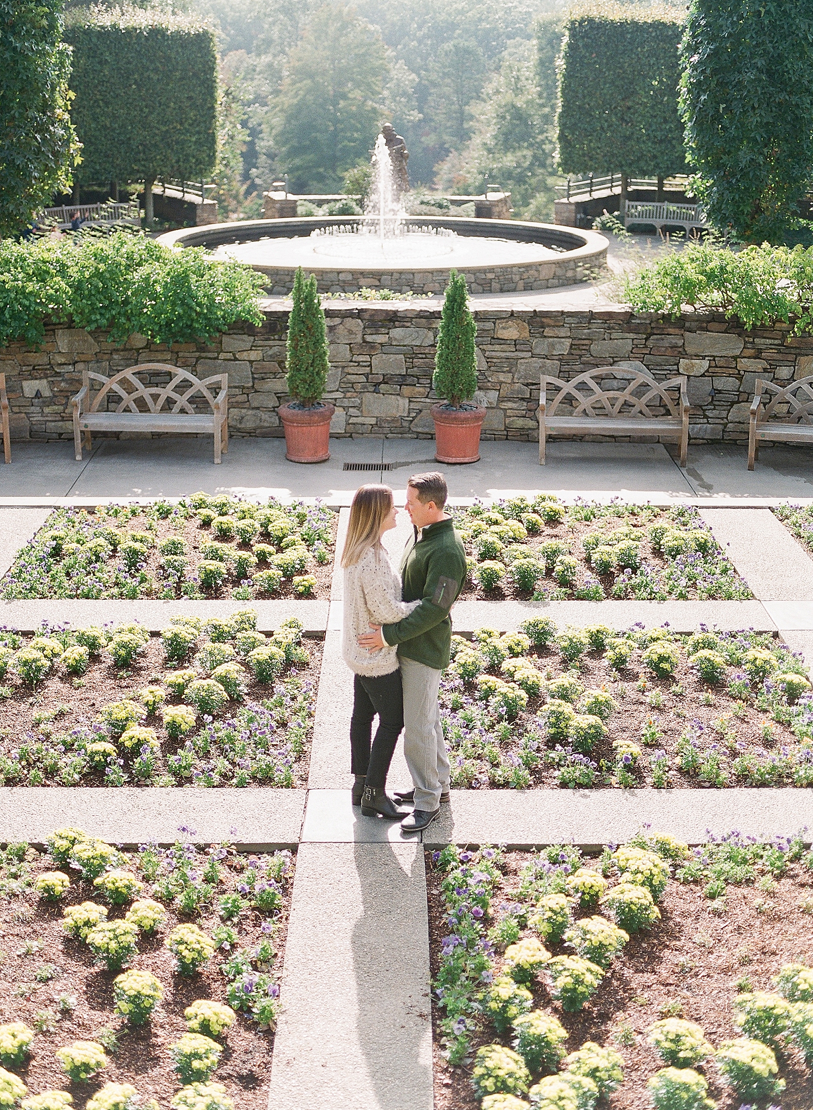 North Carolina Arboretum Couple Hugging in Garden with Fountain in background Photo