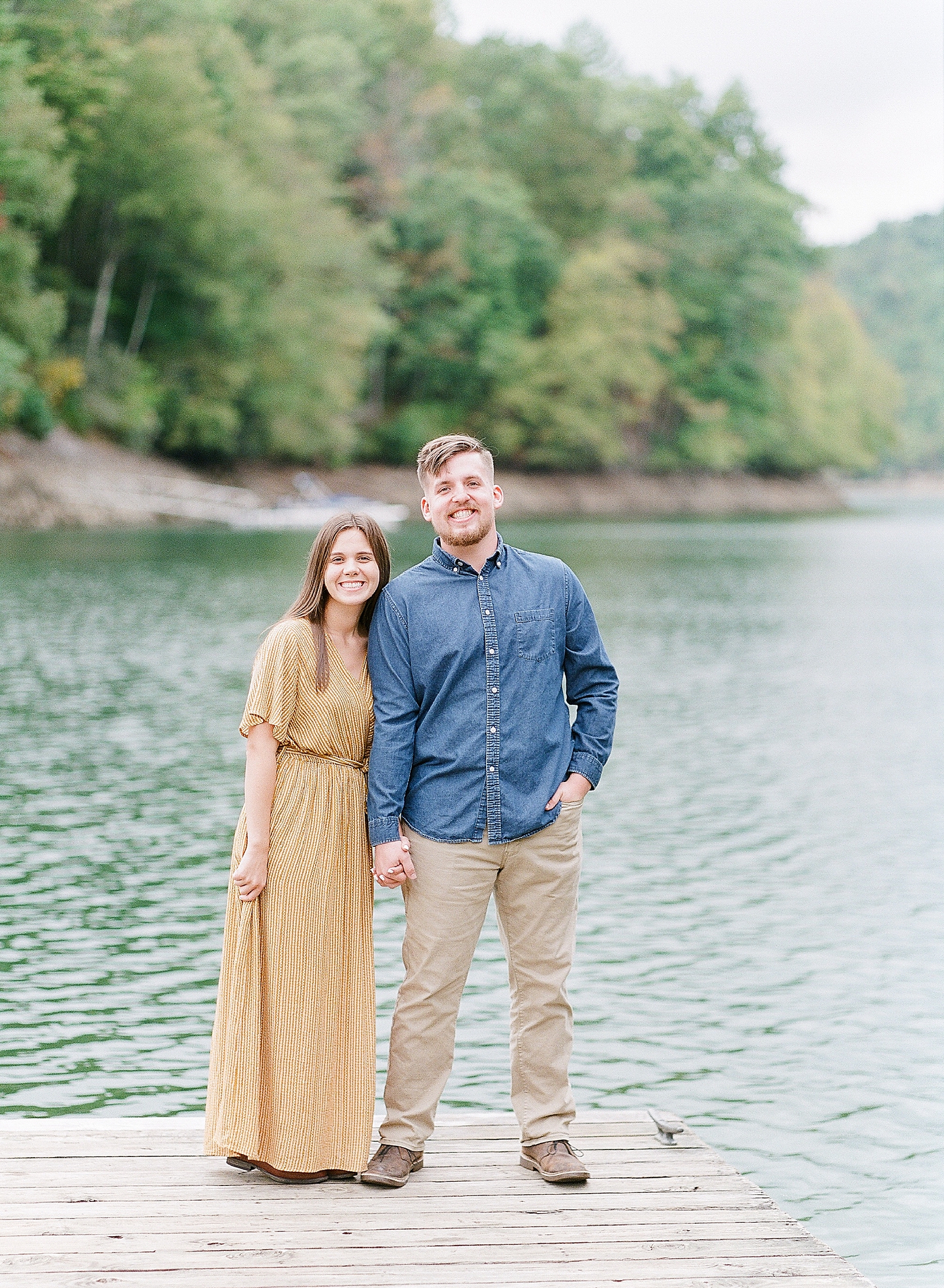 North Carolina Mountain Engagement Session Couple Holding Hands on Dock at Lake Photo