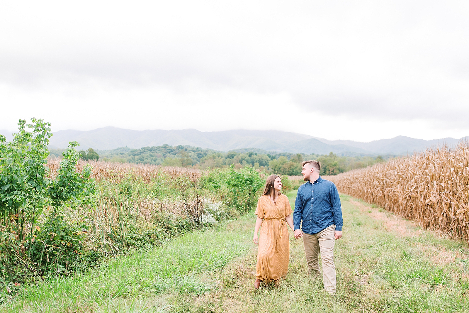  North Carolina Mountain Engagement Session Couple Walking through Field Photo
