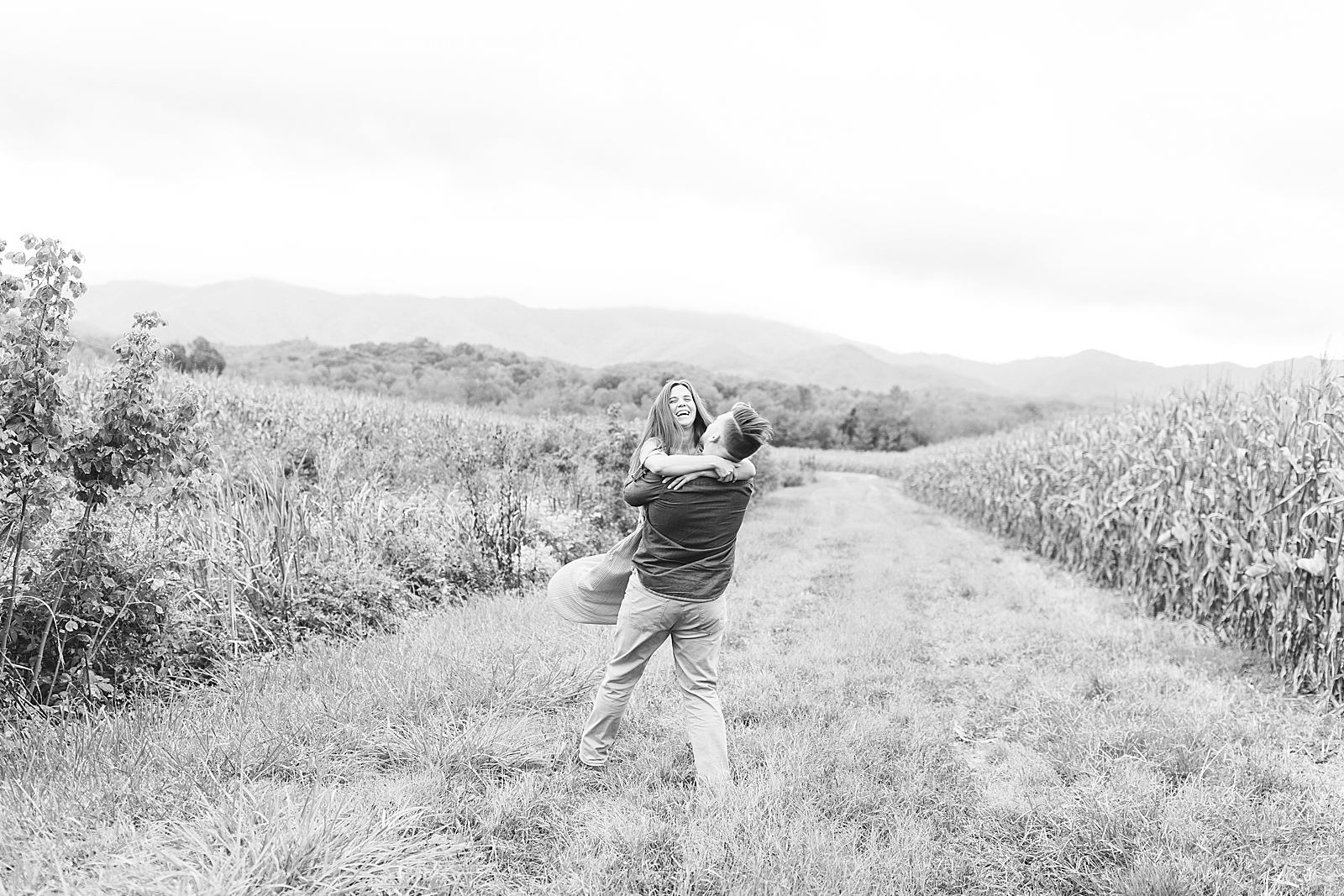  North Carolina Mountain Engagement Session Black and White of Couple Spinning in Field Photo