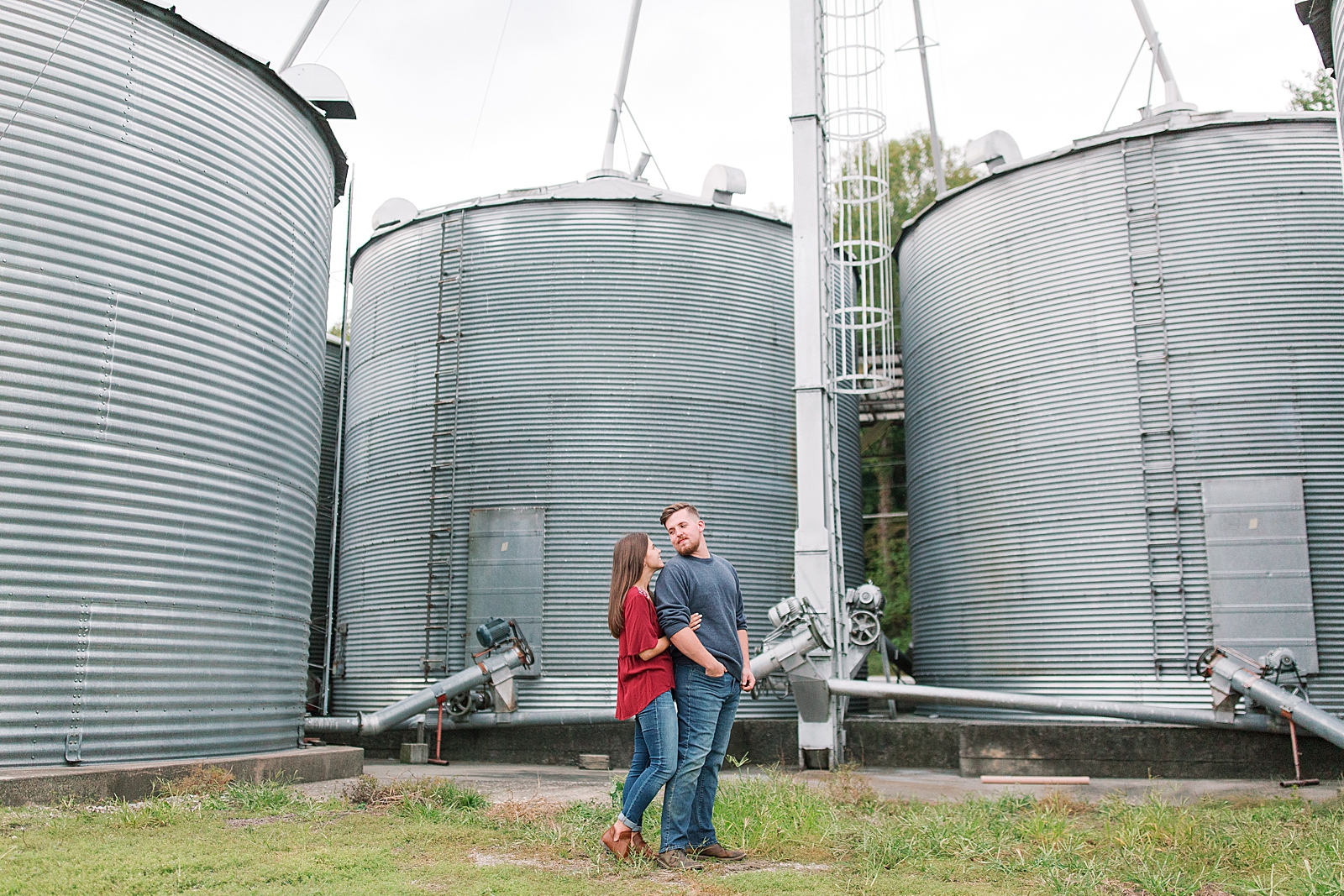  North Carolina Mountain Engagement Session Couple Looking at Each Other in Front of Silos Photo