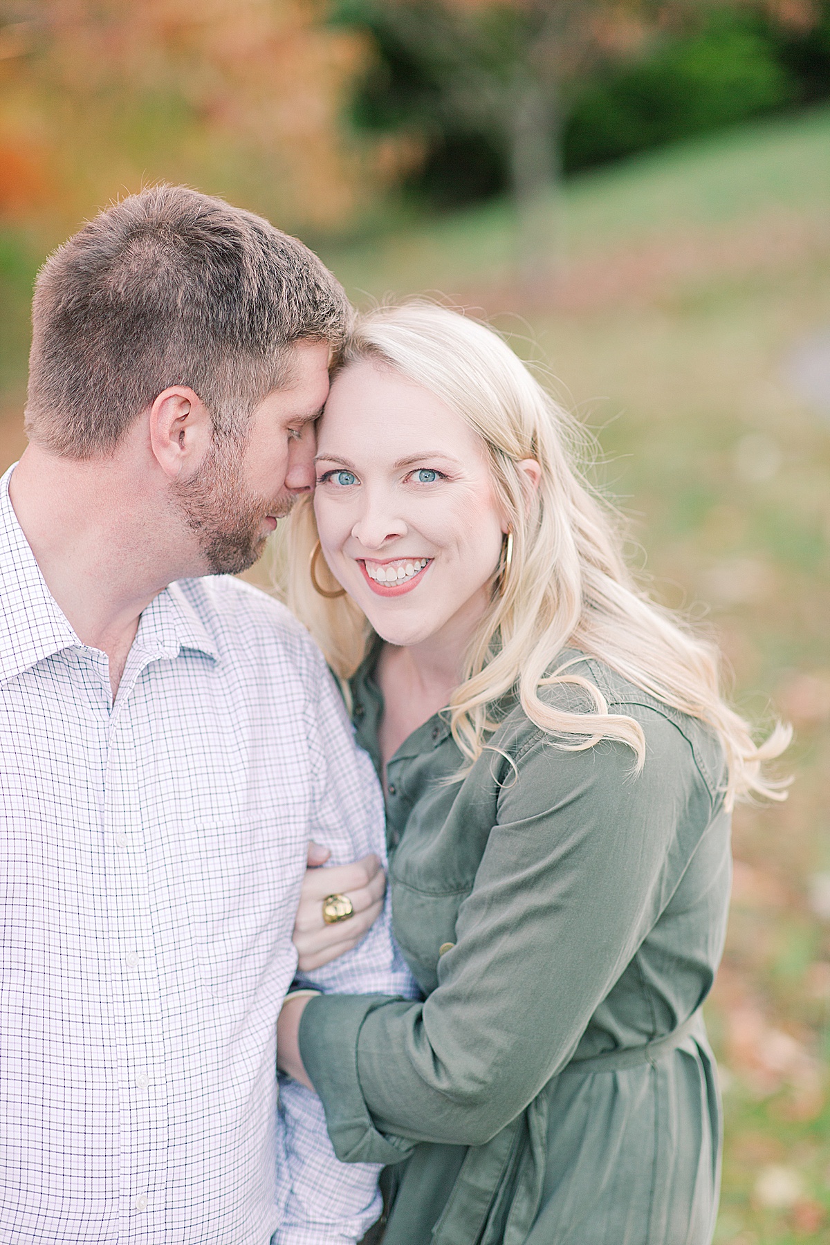 Asheville Arboretum Engagement Session Cody Smiling at Camera and Chris Snuggled In Photo