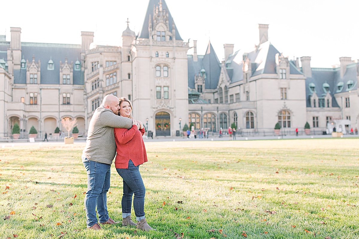 Biltmore Estate Engagement Session Couple Hugging in Front of House Photo