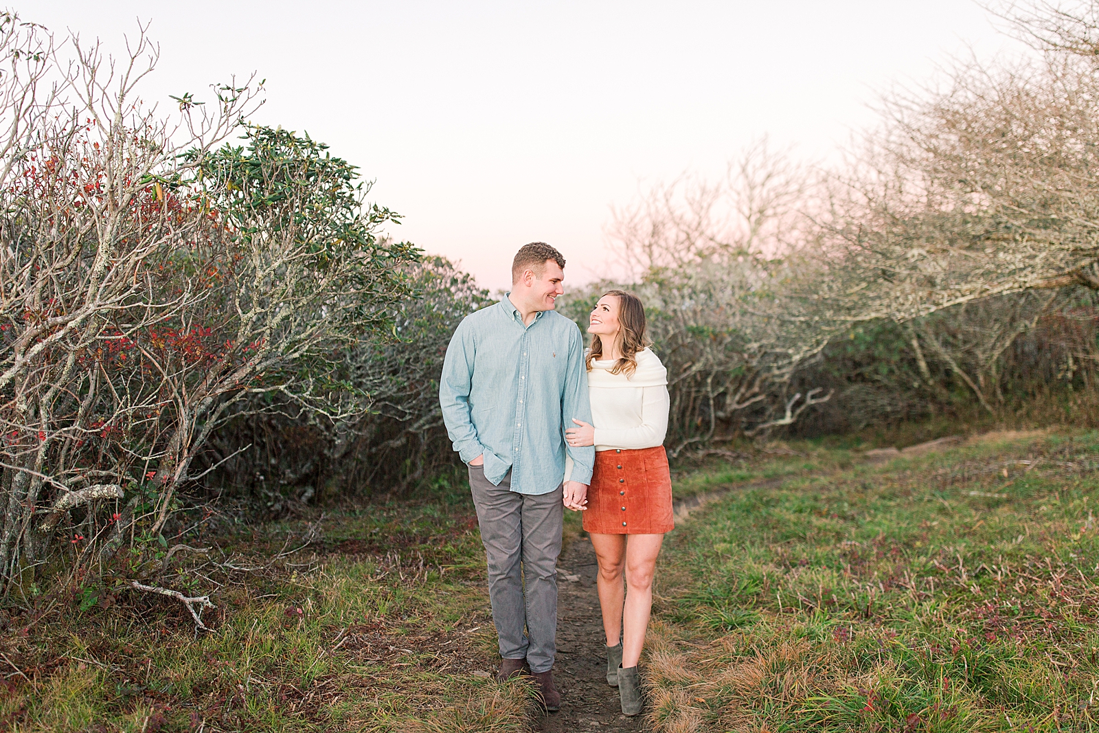Craggy Gardens Engagement Couple Smiling At Each Other Holding Hands Photo
