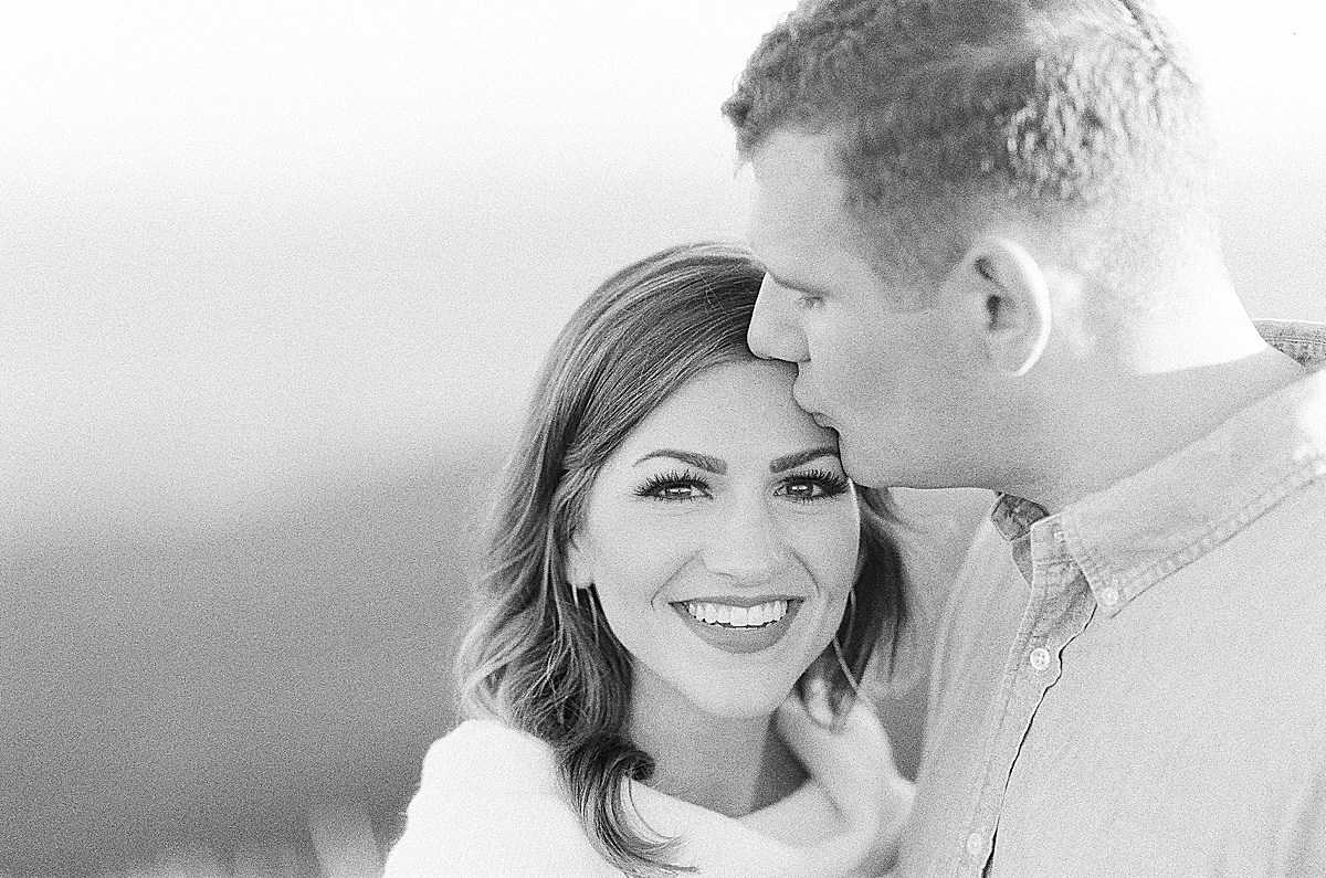 Craggy Gardens Engagement Grainy Black and White of Ross Kissing Maddie on Forehead Photo