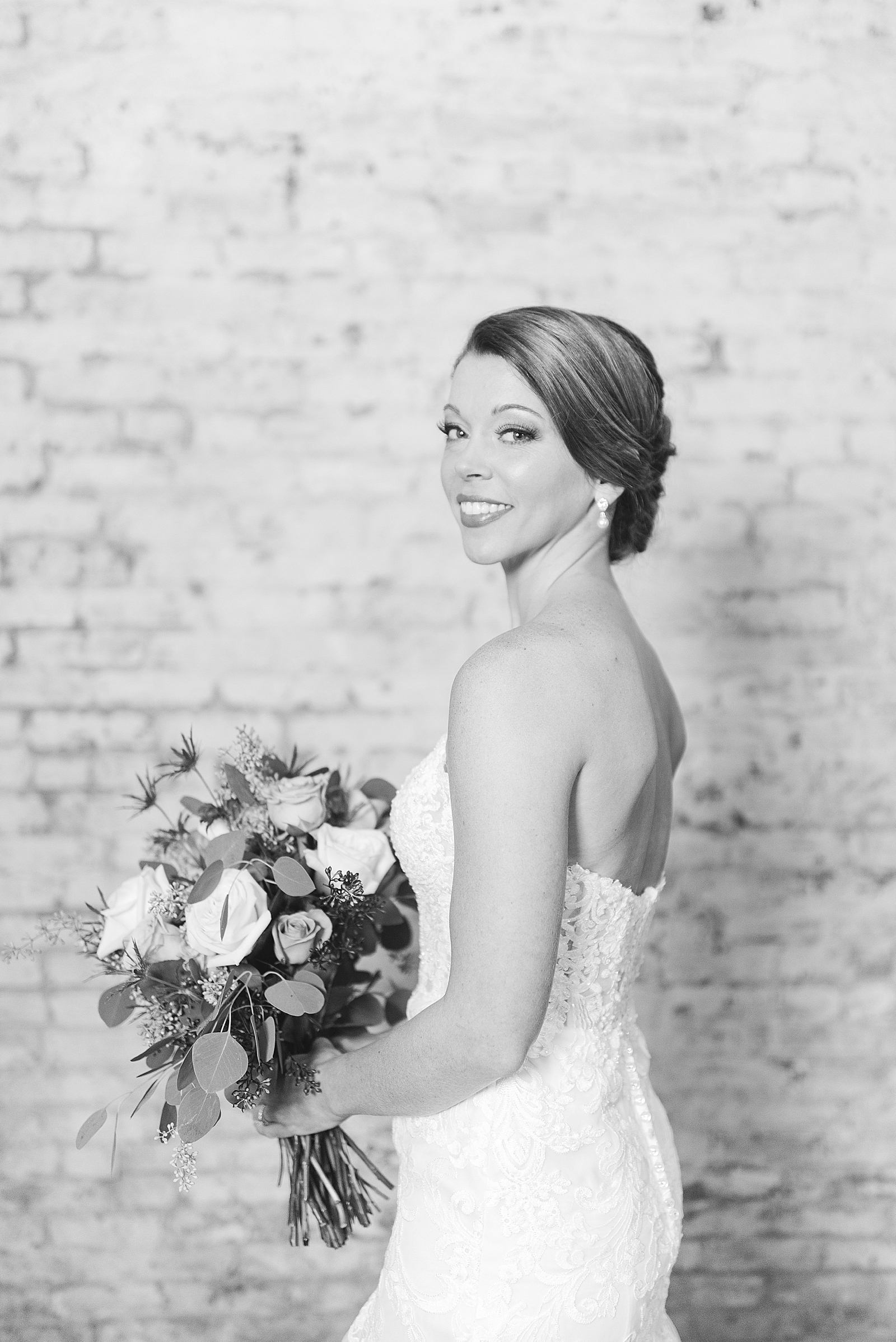 The Hackney Warehouse Black and White of Bride Smiling over her shoulder Photo
