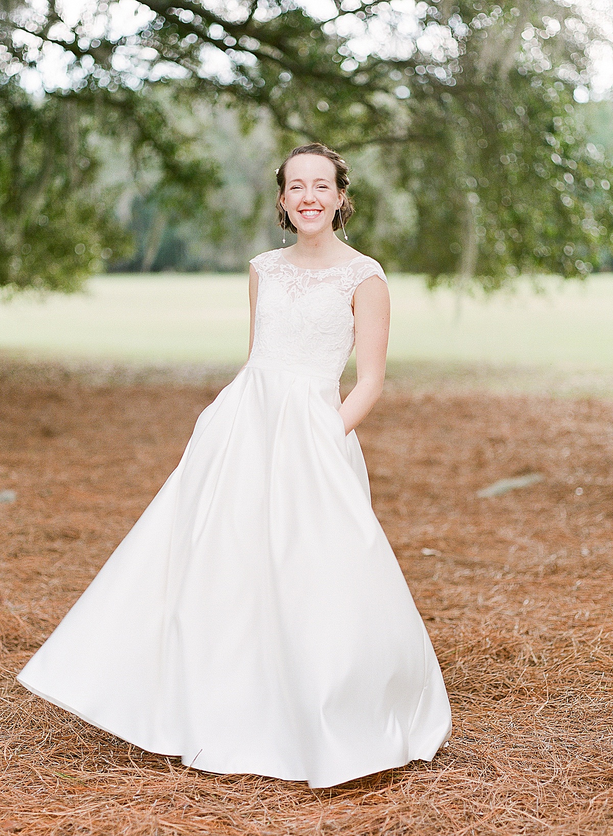 Bride twirling in Wedding Dress Under Trees Photo 