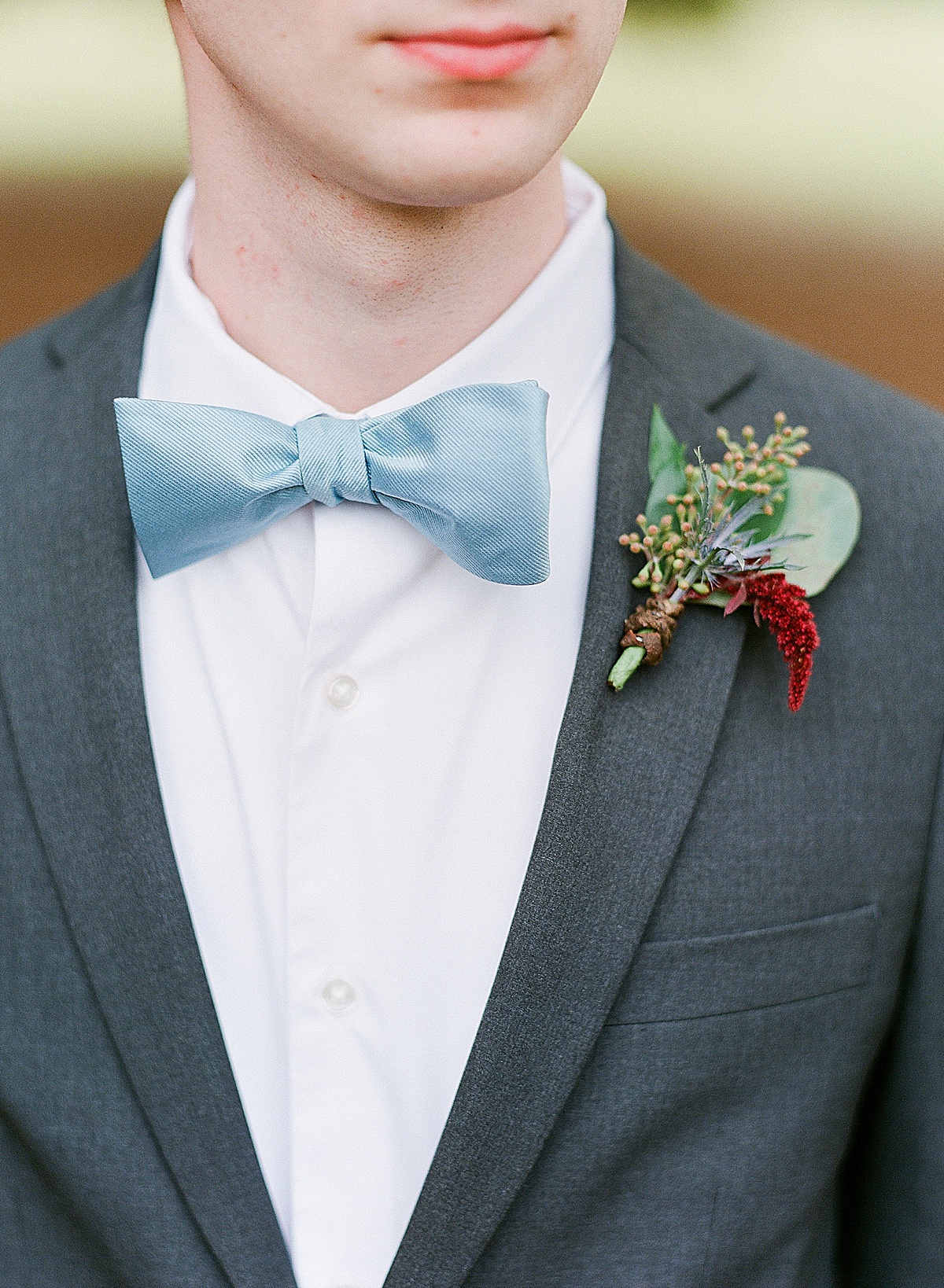 Detail of Grooms Blue Bow Tie and Boutonniere Photo 