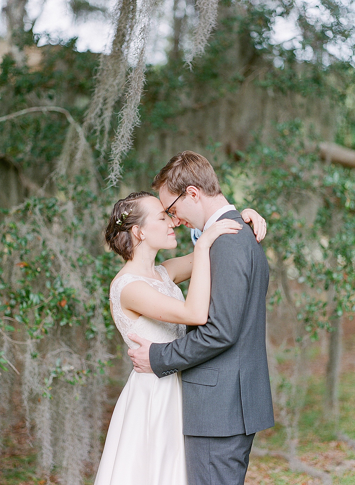 Bride and Groom Hugging Nose to Nose Under Big Oak Tree Photo 