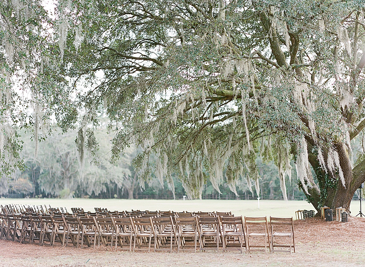Hewitt Oaks Wedding Venue Ceremony Site under Big Oak Tree with Chairs Photo 