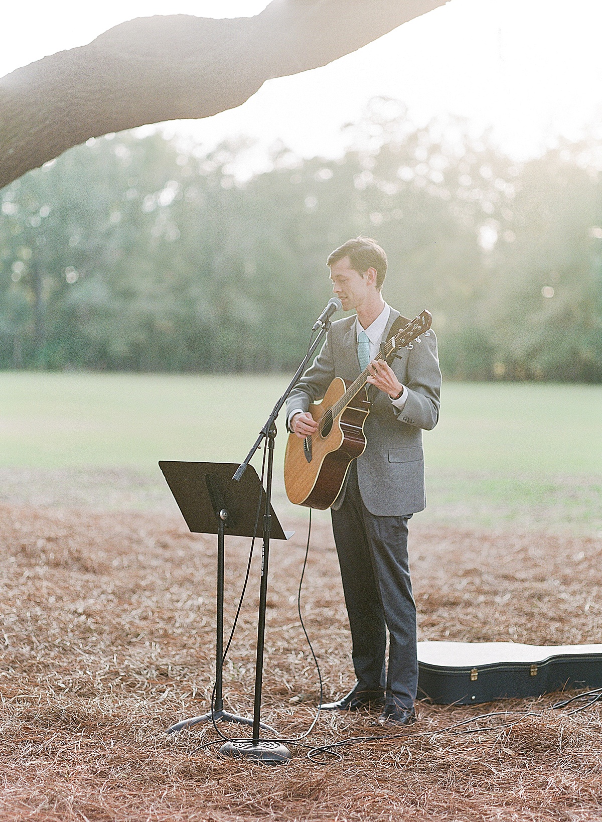 Bride and Grooms Friend Singing and Playing Guitar During Ceremony 