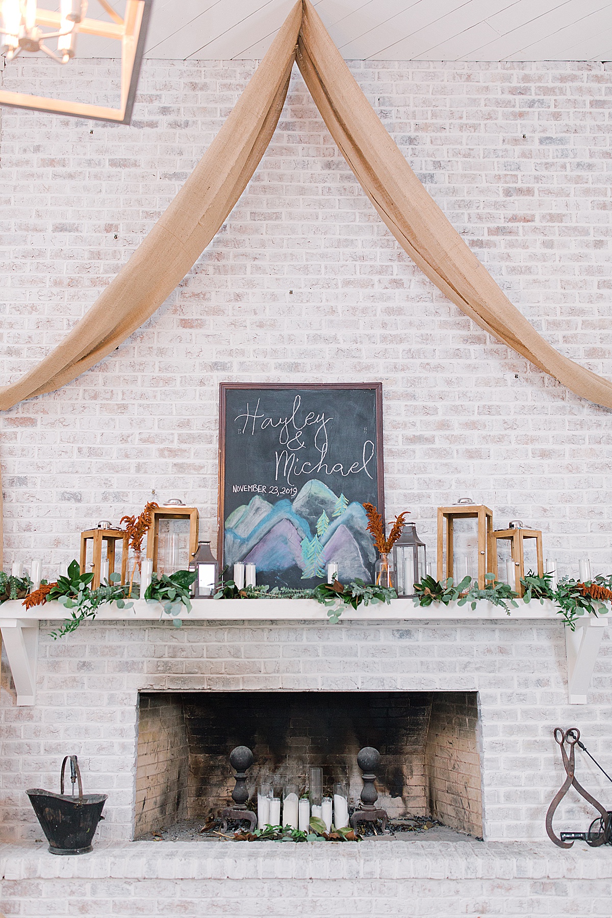 Chalkboard Sign that Says Hayley and Michael over Fireplace Mantel 