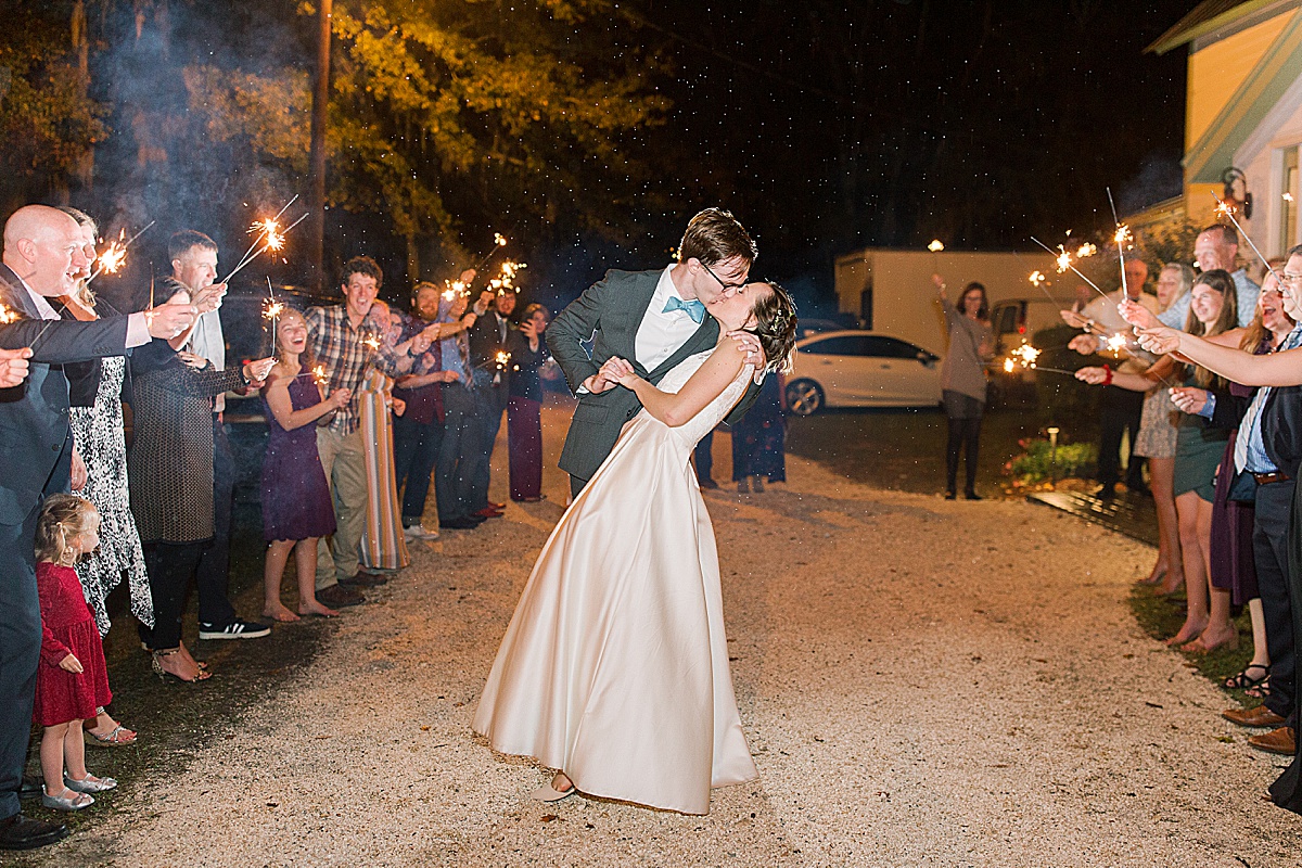 Wedding Sparkler Exit Bride and Groom Kissing in the Rain 