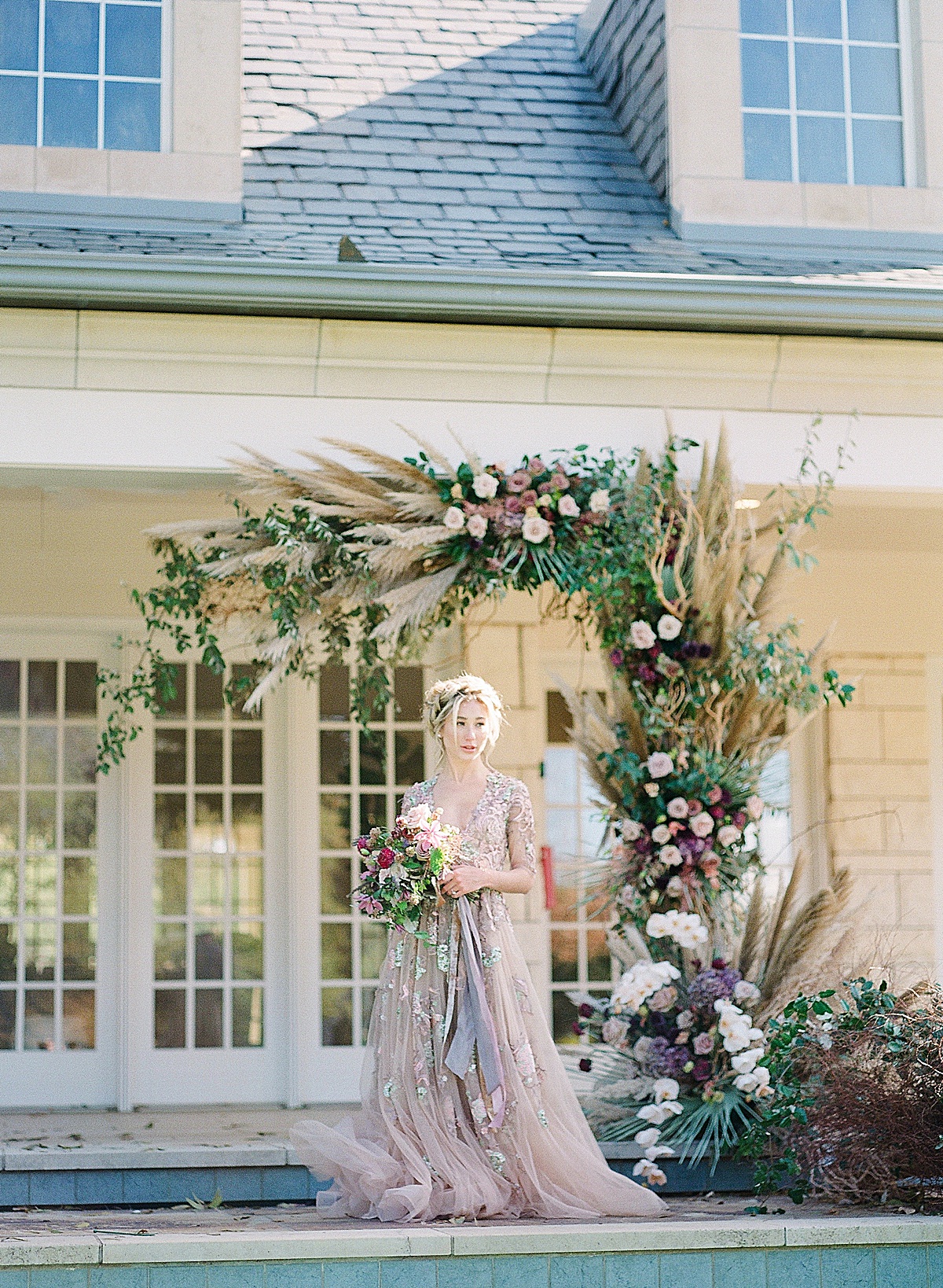 Lavender Wedding Dress Inspiration shoot Bride at ceremony site surrounded by florals photo