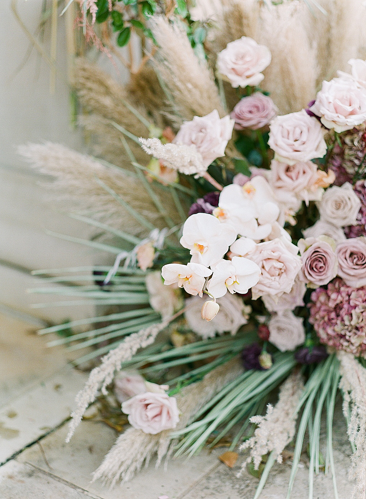 Orchids Lavender Roses and pampas grass wedding ceremony florals 