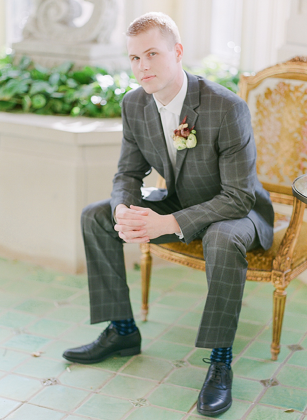 Groom Smiling at Camera Sitting in Yellow Chair 