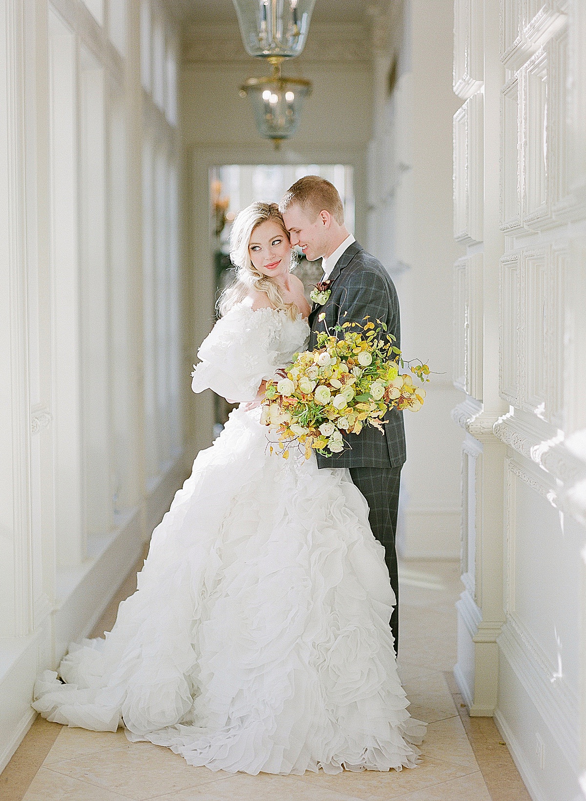 7 Reasons Why We Still Shoot Film Bride and Groom Hugging in Hallway Photo