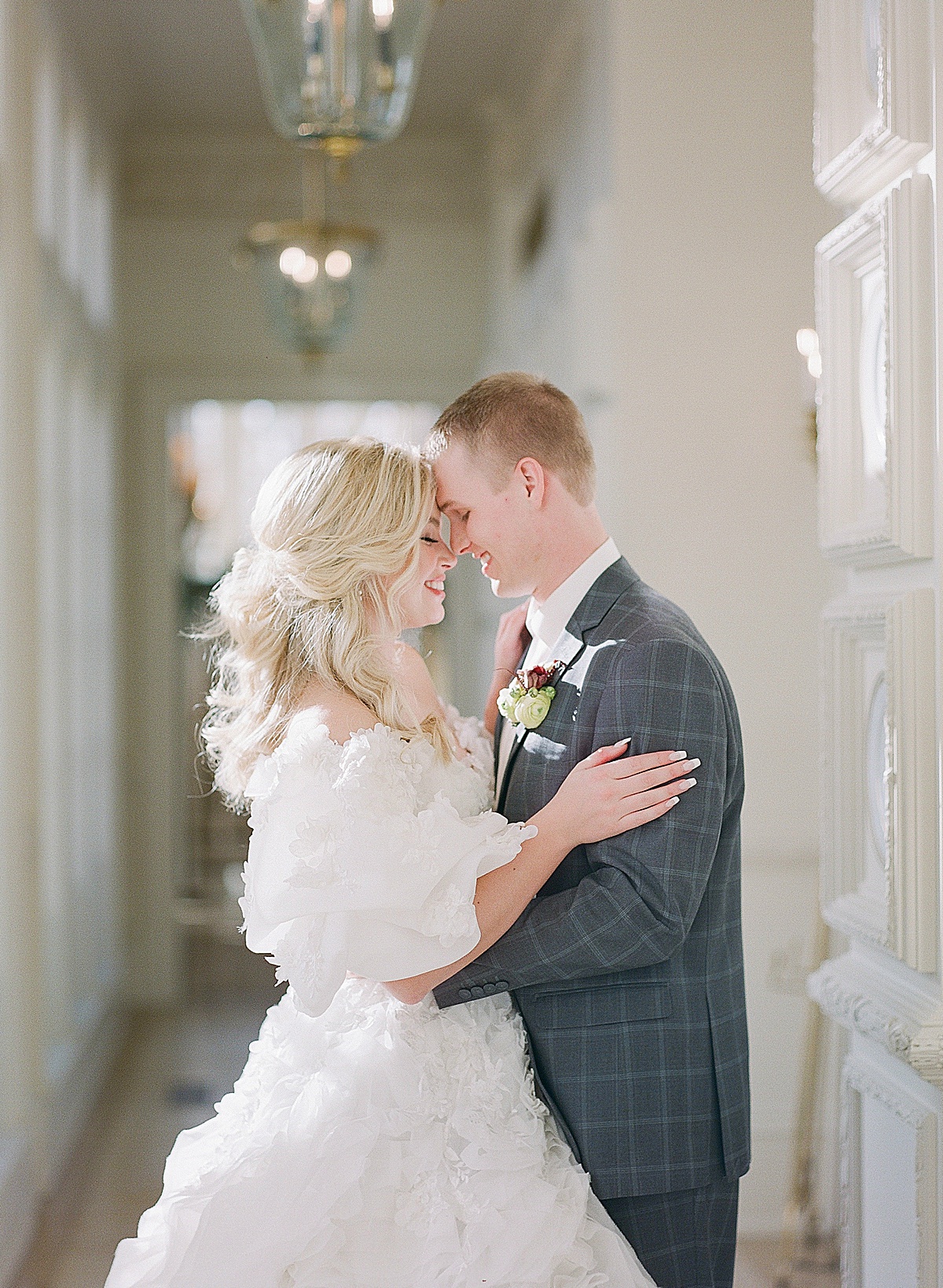 Bride and Groom Smiling Nose to Nose In Hallway Photo 