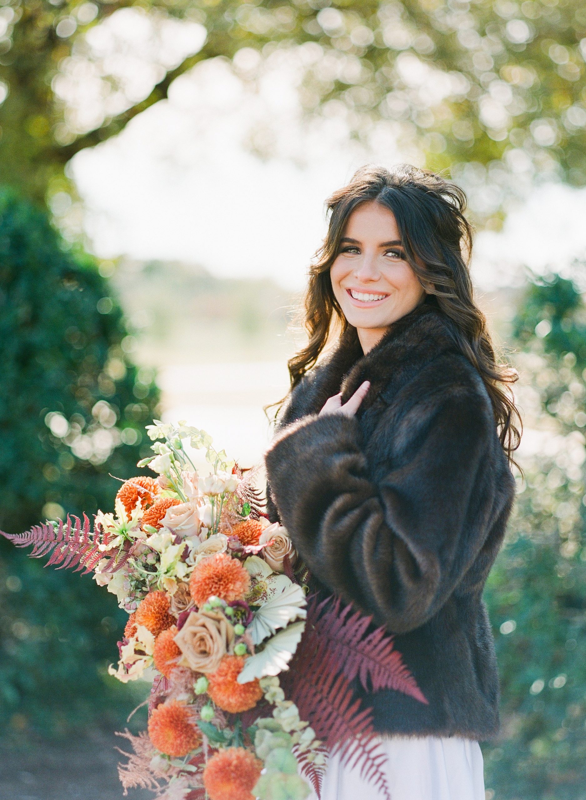 Bride in Brown Fur holding fall colored Bouquet Photo