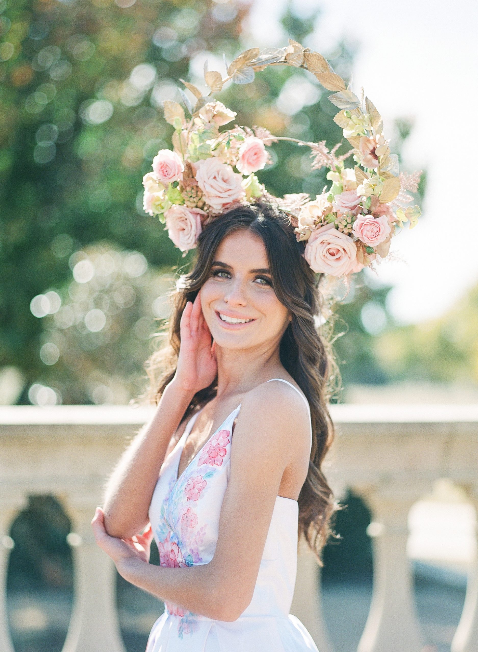 Bride Smiling in Hand Painted Wedding Dress with Floral Headdress Photo