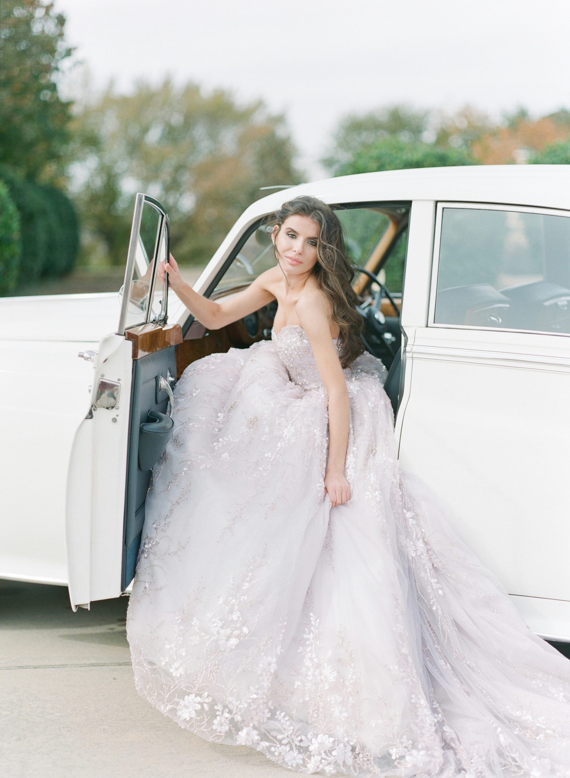 Bride in Lavender Gown Sitting in Drivers seat of Rolls Royce 