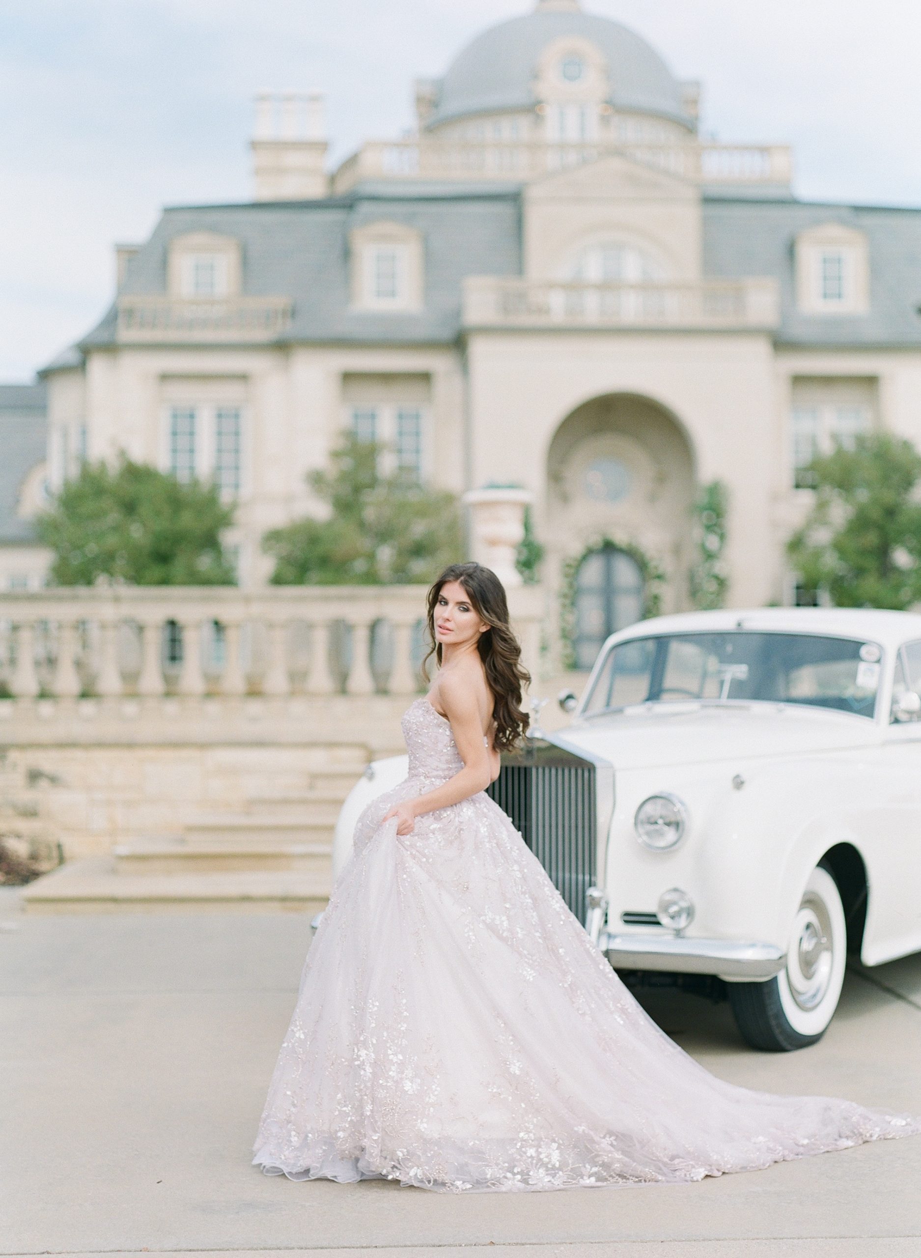 Bride in Lavender Gown in front of Olana Venue in Texas in front of a Rolls Royce