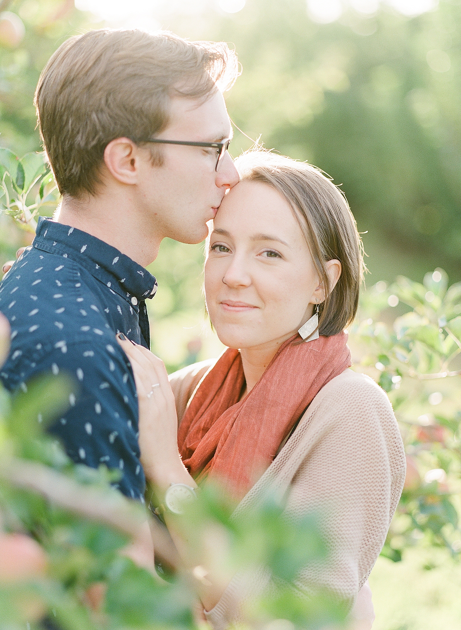 Top Asheville Engagement Photo Location Couple Snuggling in Apple Orchard Photo 