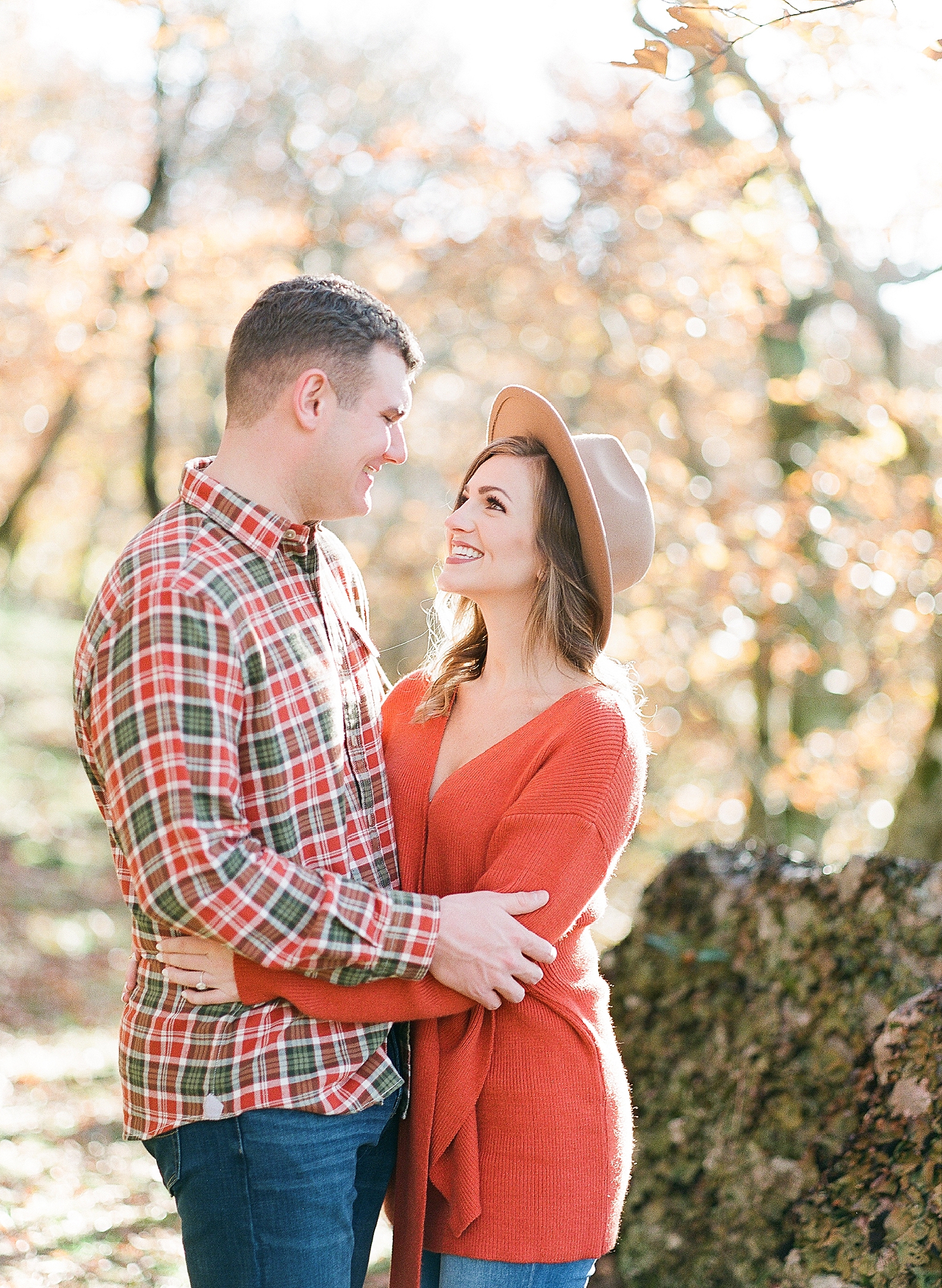 Couple Smiling At Each Other Hugging During Engagement Session Photo