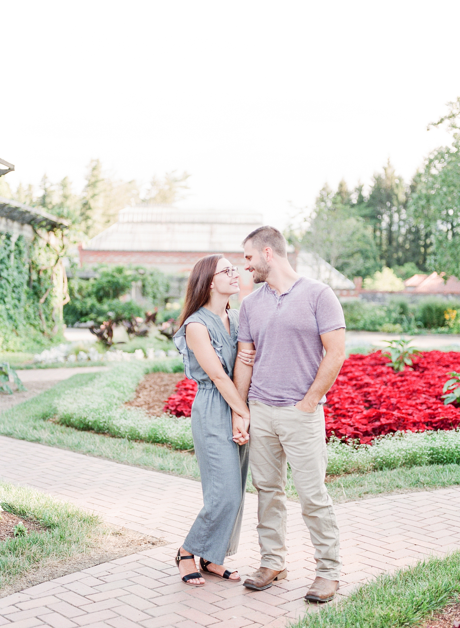 How To Have The Best Engagement Photos Couple At The Biltmore Gardens Holding Hands Smiling At Each Other Photo